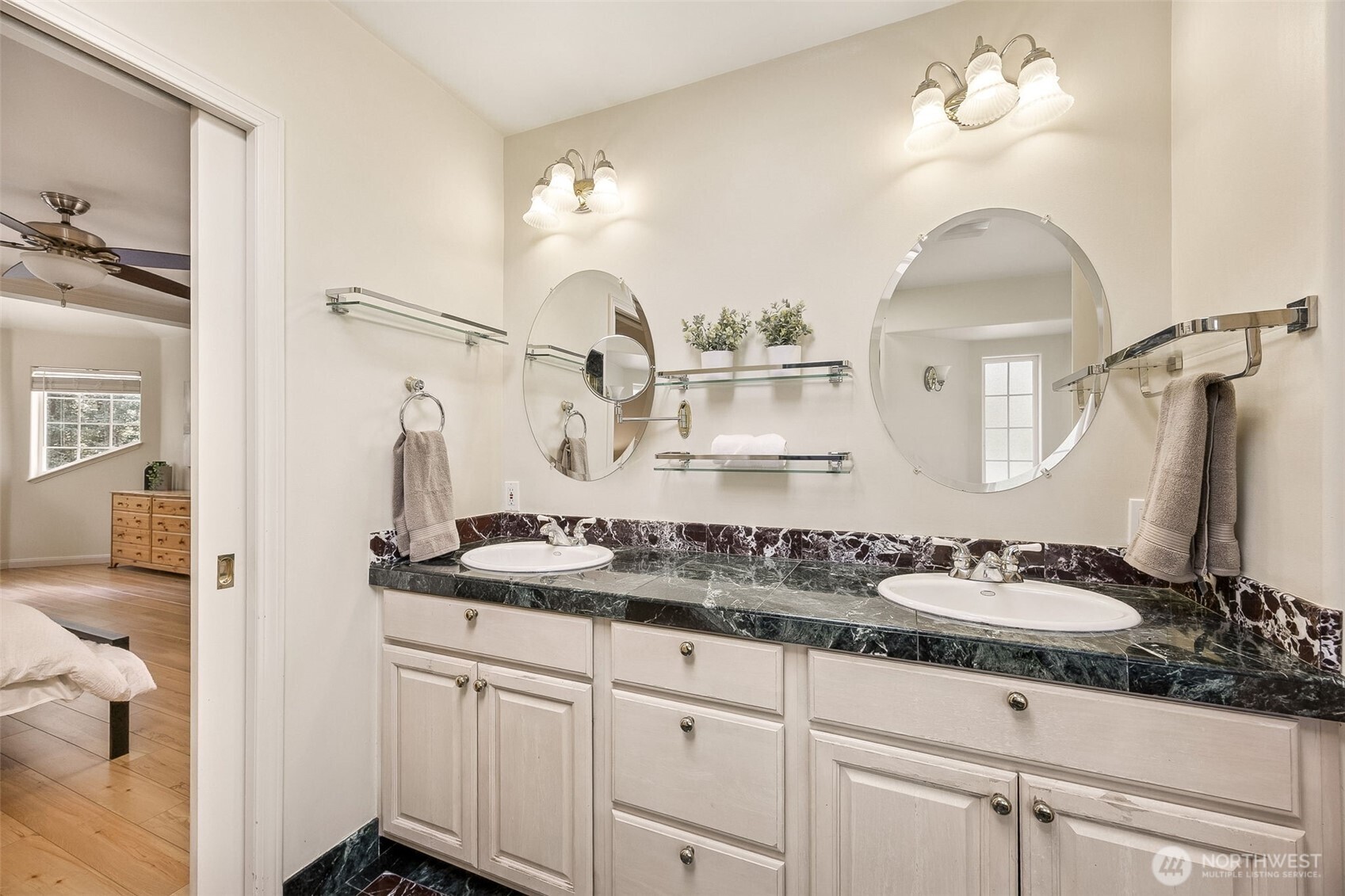 Luxurious en-suite bath offers a large double sink vanity, loads of storage space and exquisite lighting and mirrors.