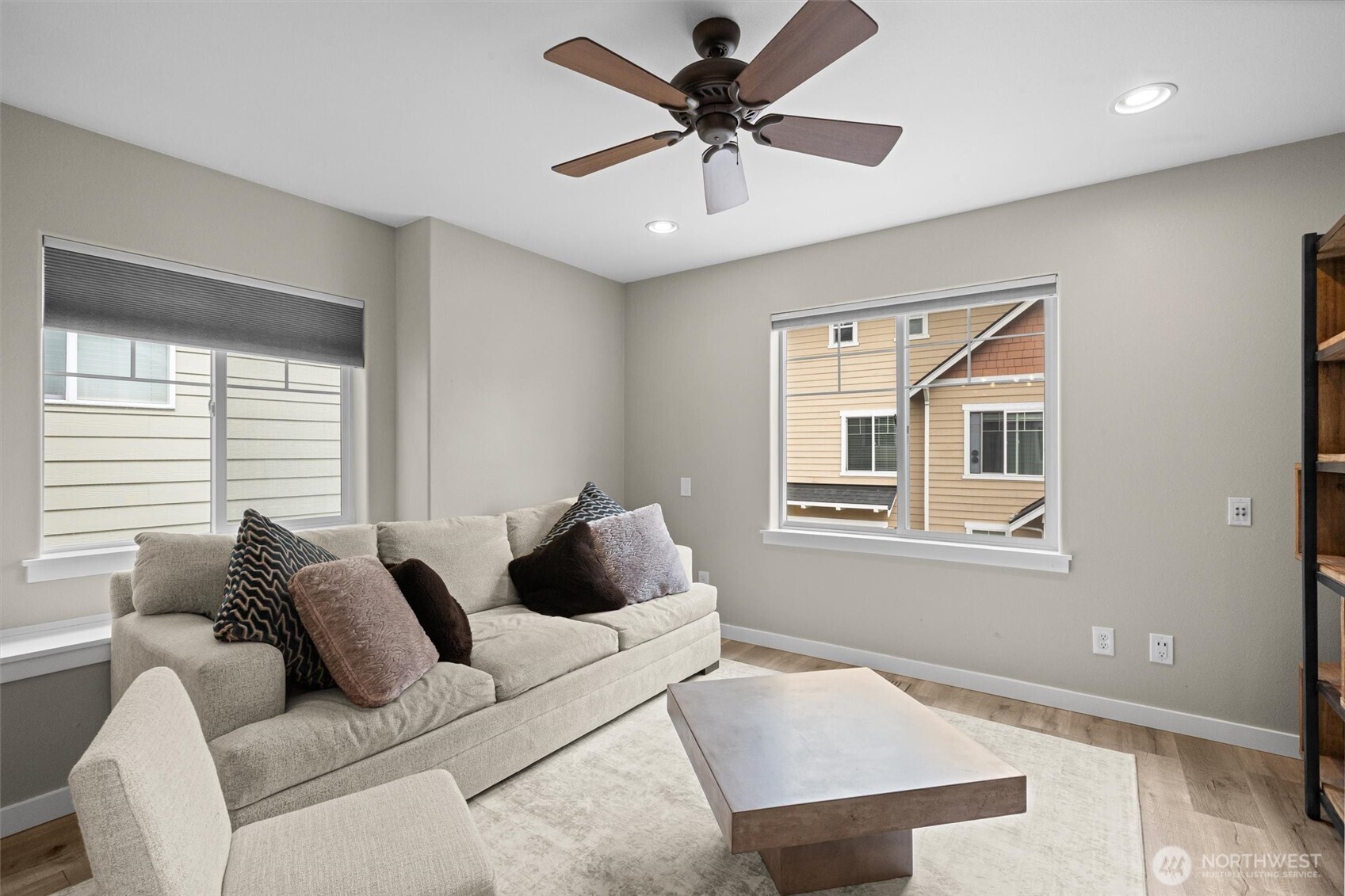 Custom blinds have been added to each vinyl window and the ceiling fan has been installed for comfort.