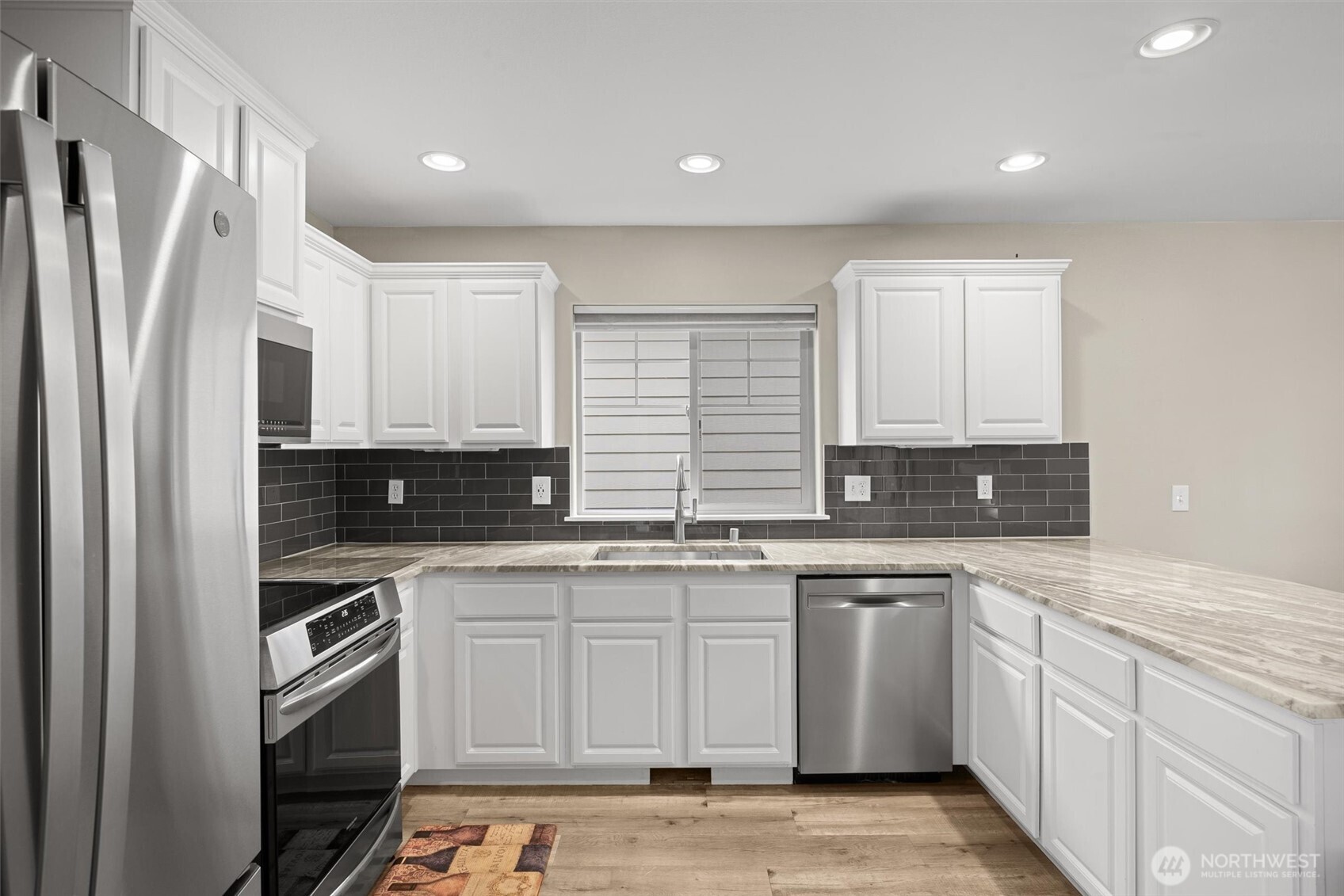 The stainless appliances are just 3 years old. The counters are quartz. The subway tile is timeless.