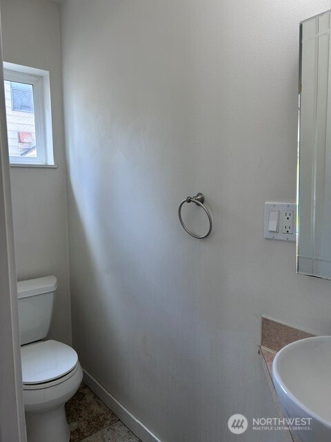 Powder room with window and tile floor