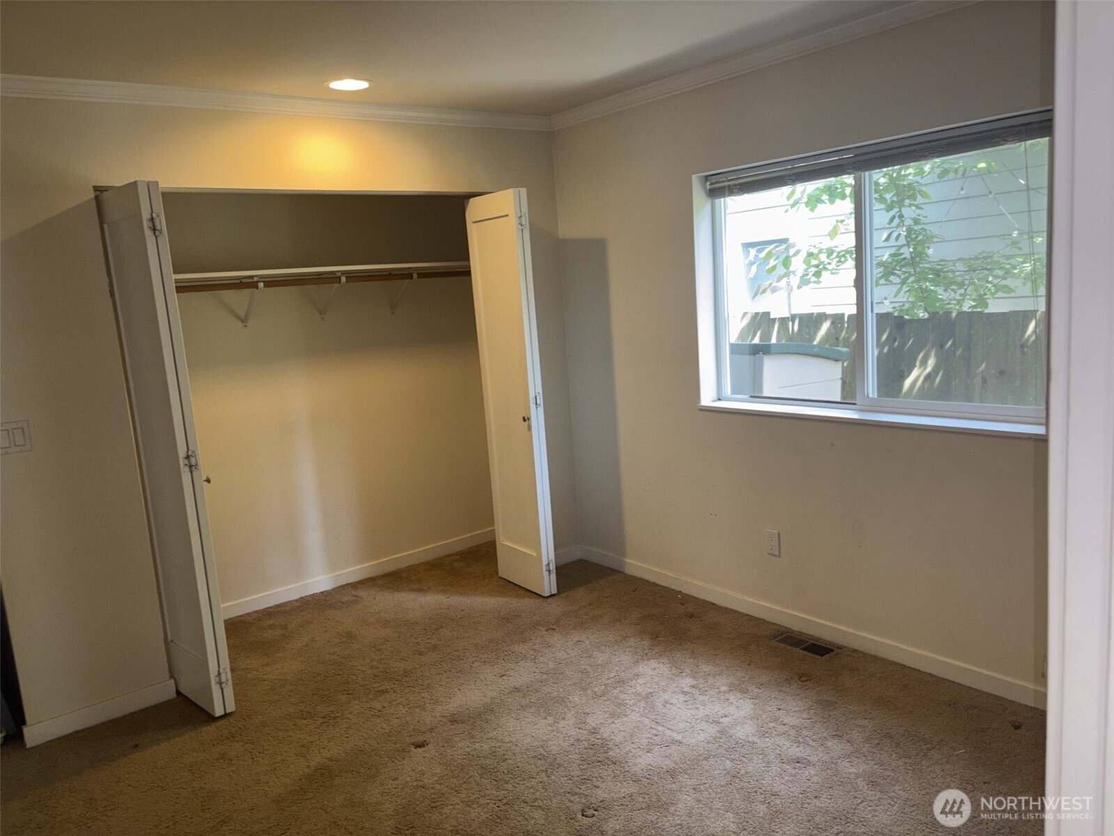 Primary bedroom with long closet for hanging clothes.