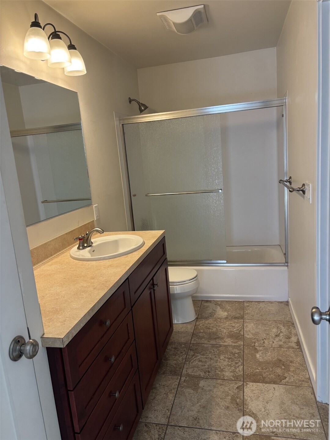 Primary bath has linen closet at left of vanity.