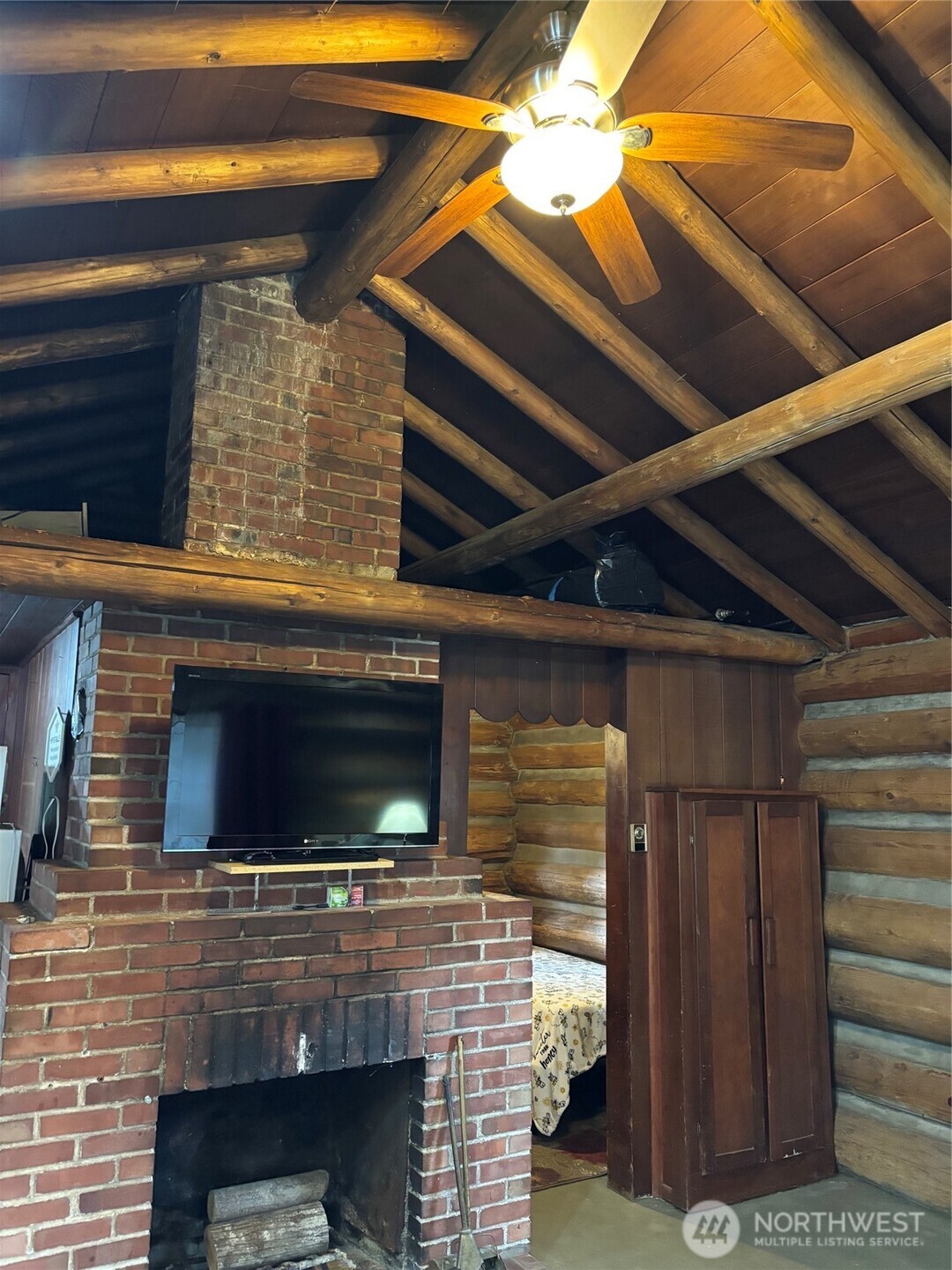 There are 2 loft areas above on either side of masonry chimney to place a bedroll or store tons of 'stuff' away