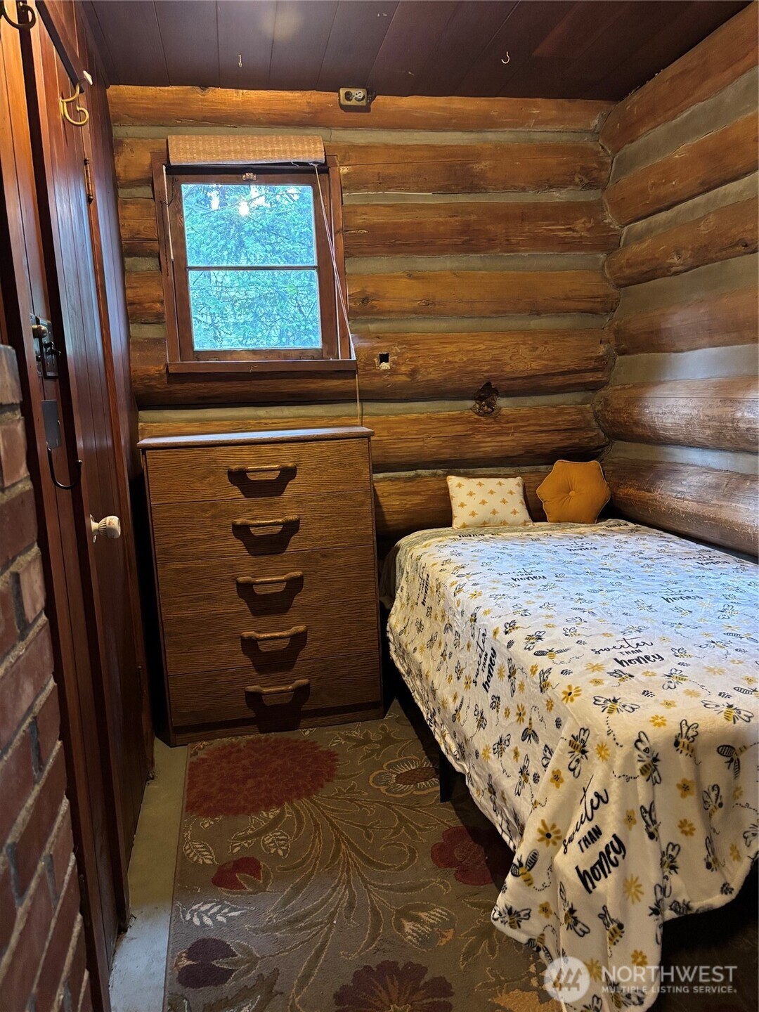 Bedroom with dresser, storage closet and long twin fits for tall people.