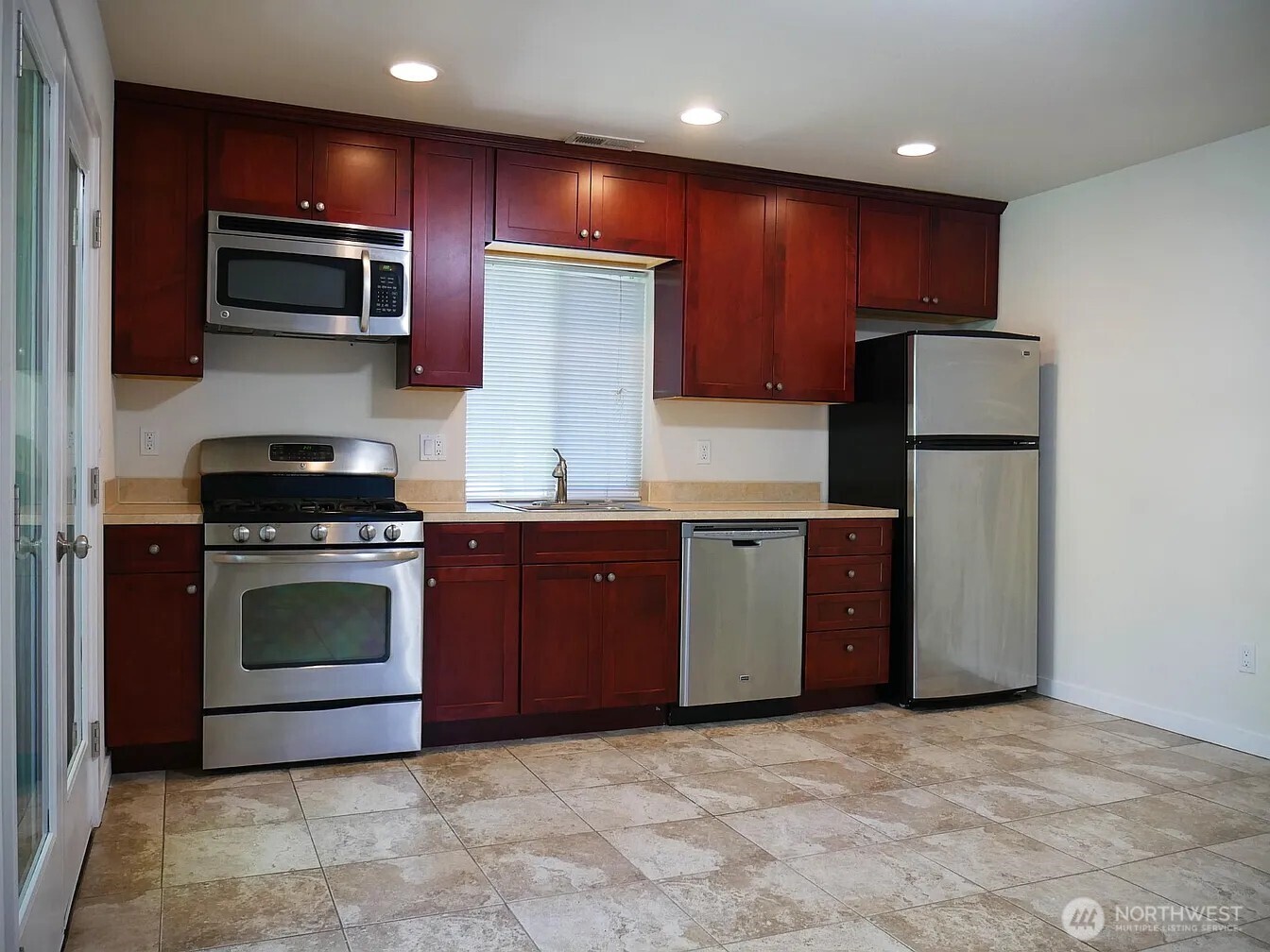 The great room is large enough for complete living room and dining area.  The French doors at left were shown on the 2nd photo in this reel. That photo talked about the creek and community.