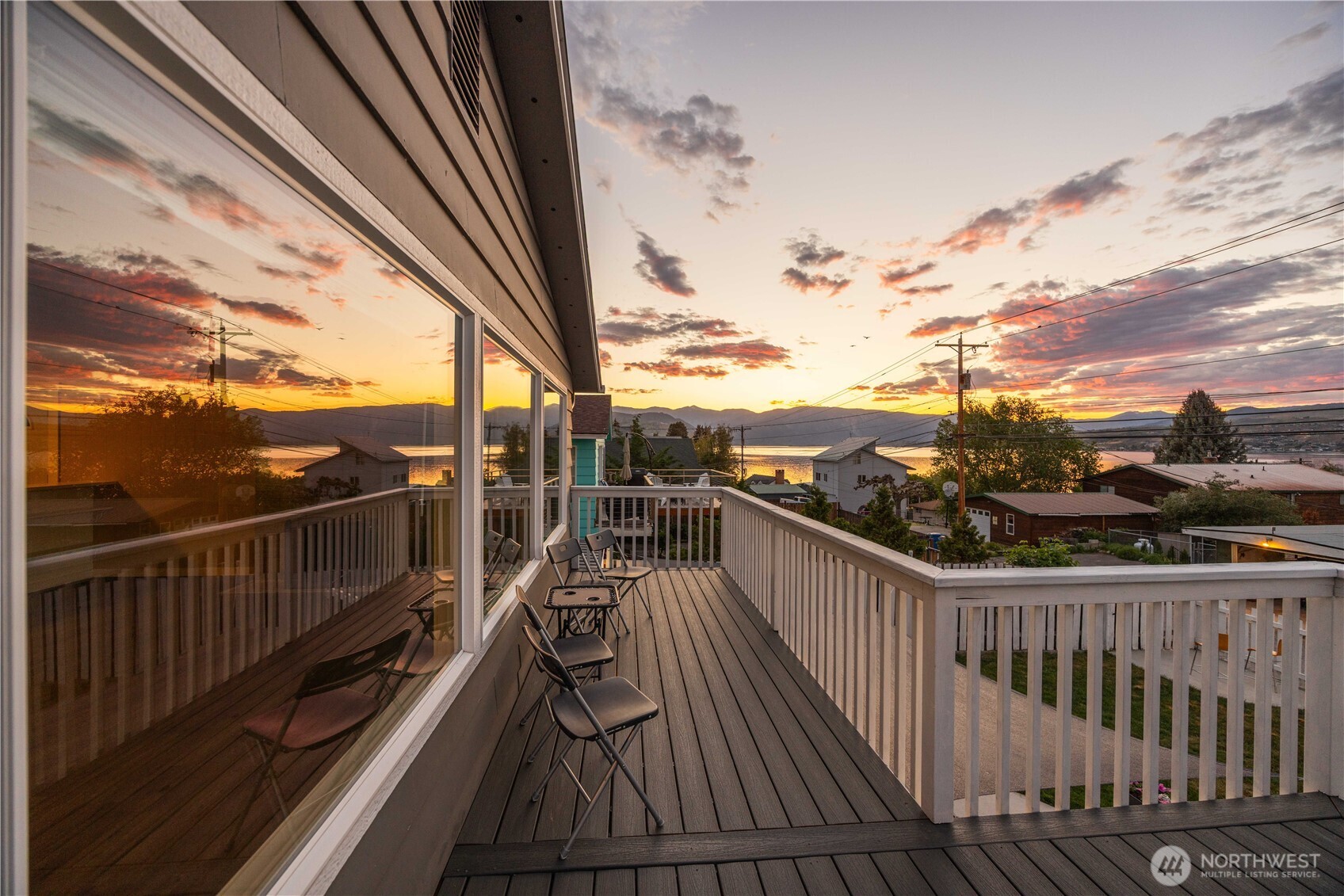 Twilight view of main level lake view deck.