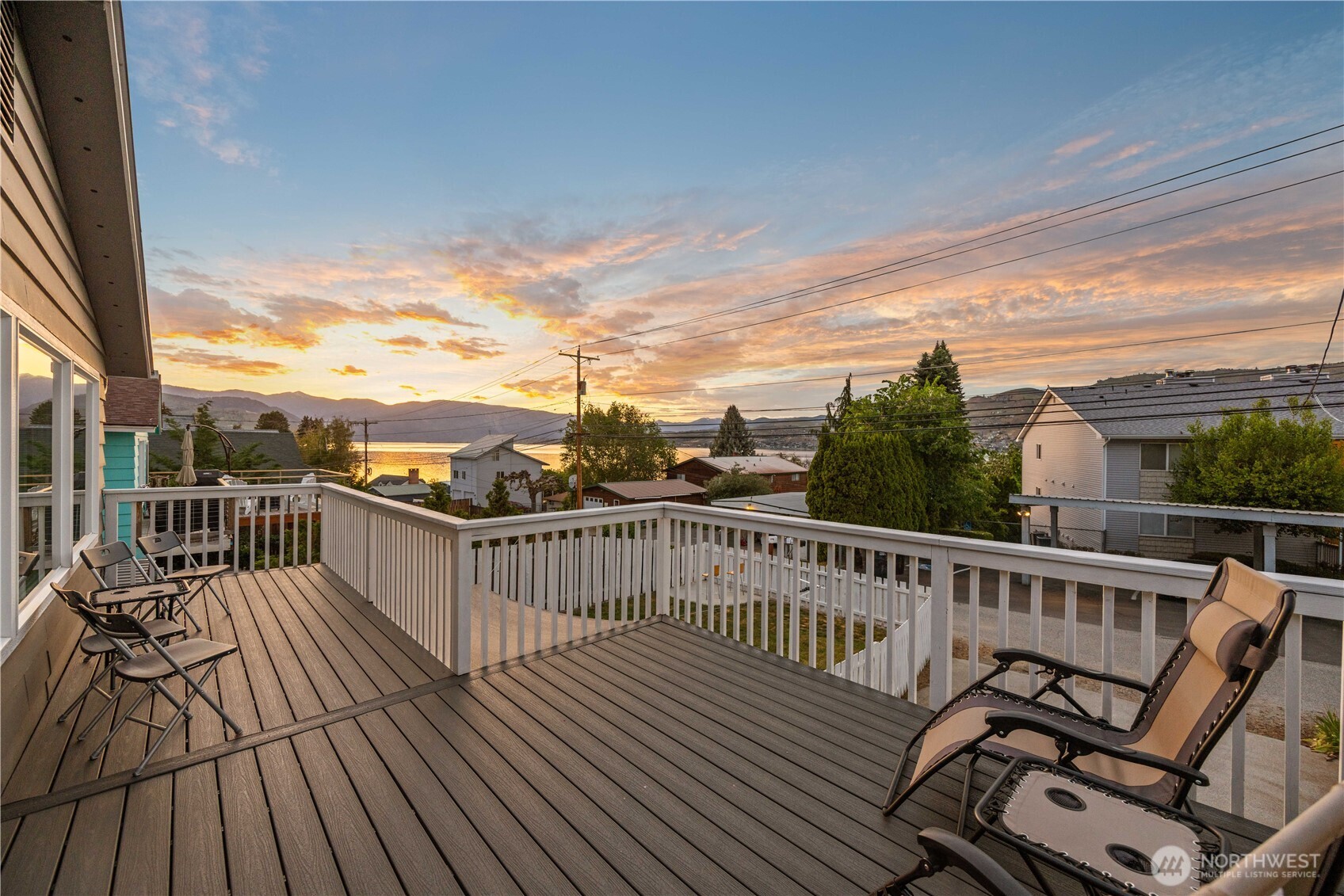 Twilight view of main level lake view 240sf deck.