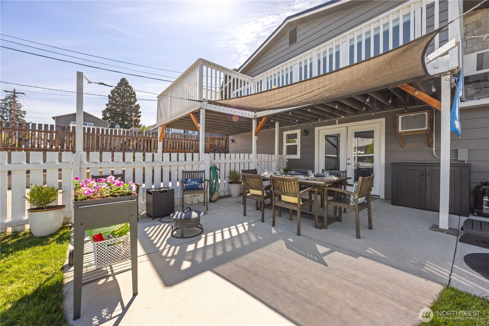 Exterior view of home and fenced outdoor living area.