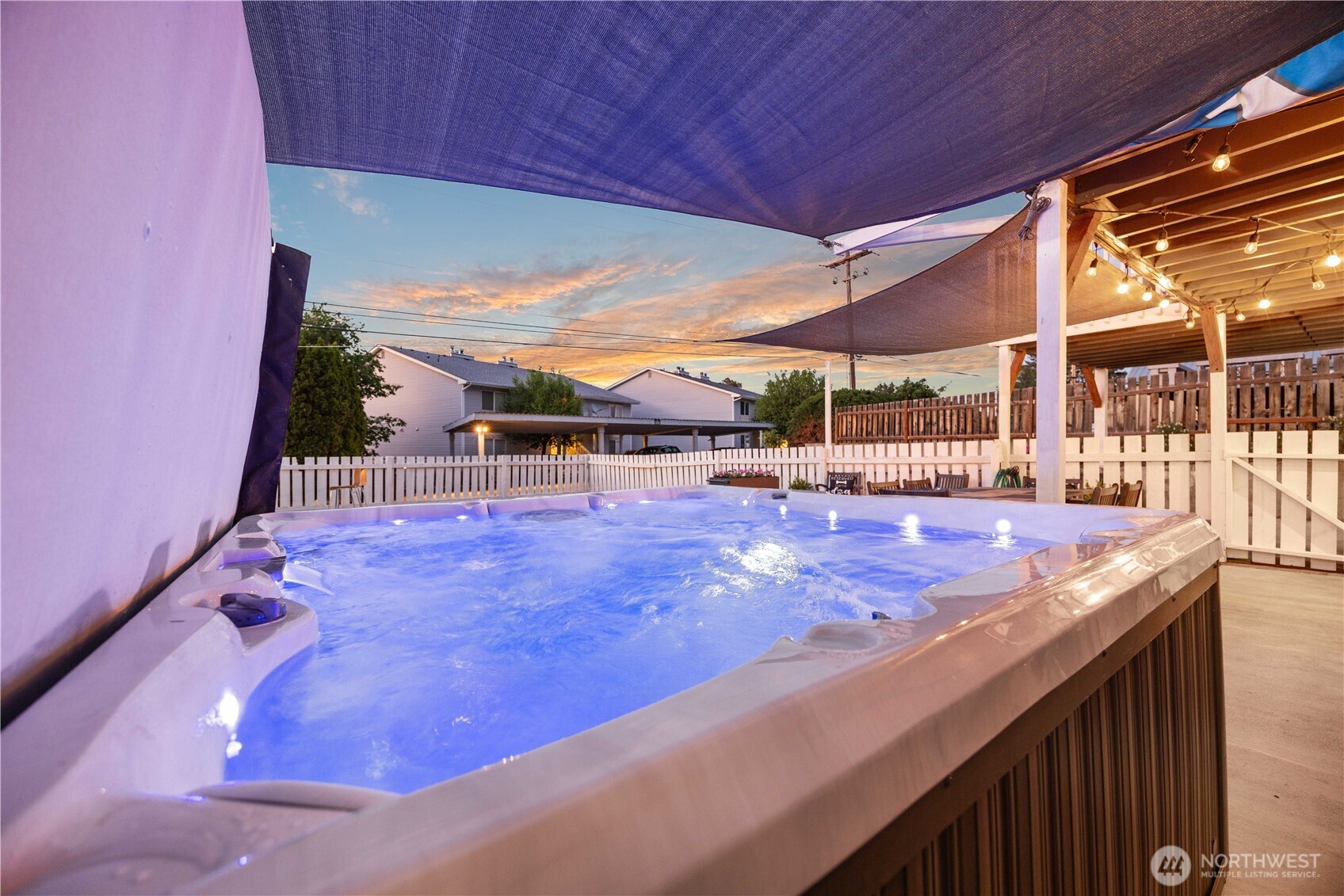 Twilight view of private hot tub and outdoor living area.
