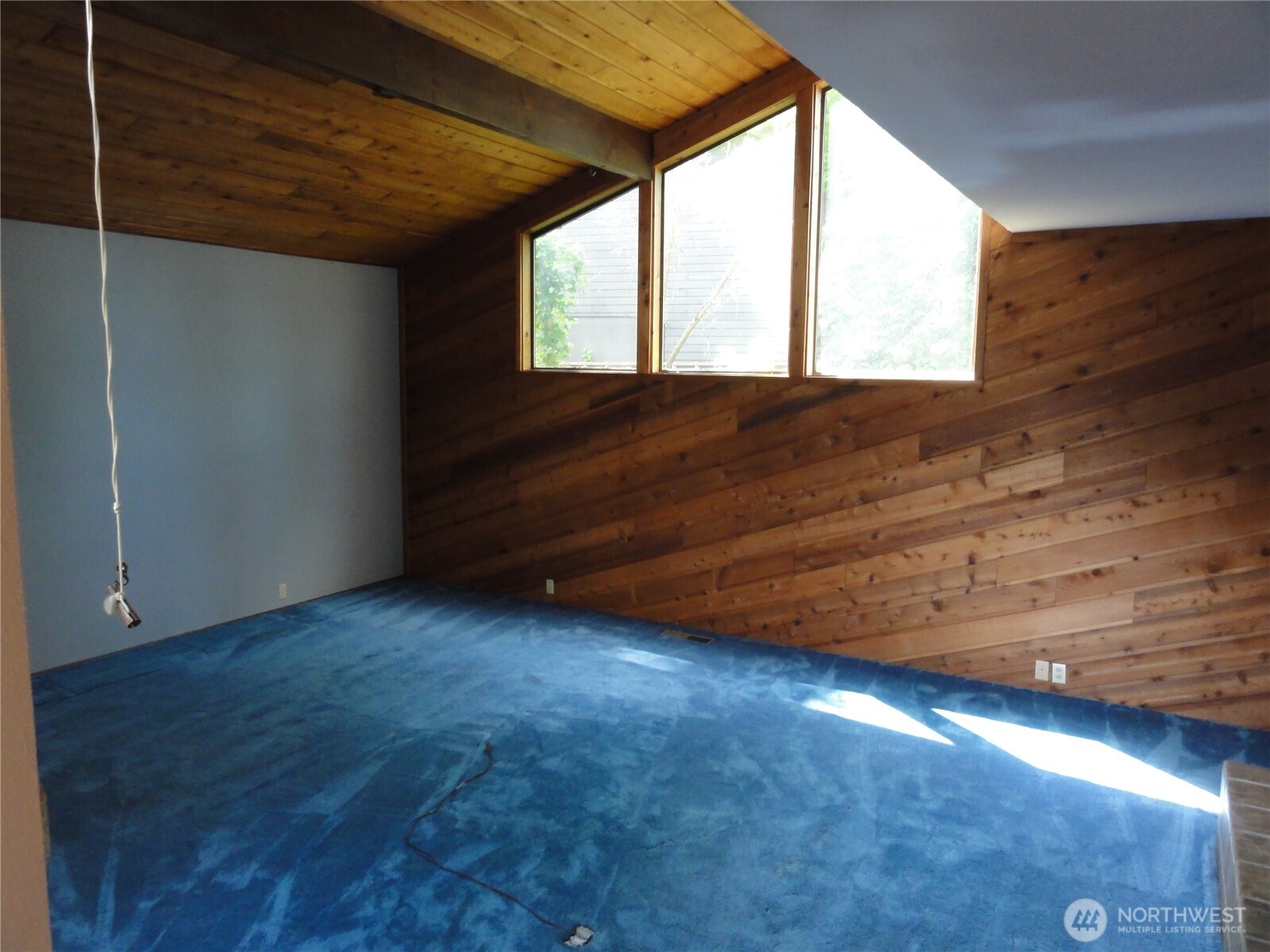 Formal living room offers cathedral ceilings and fireplace.