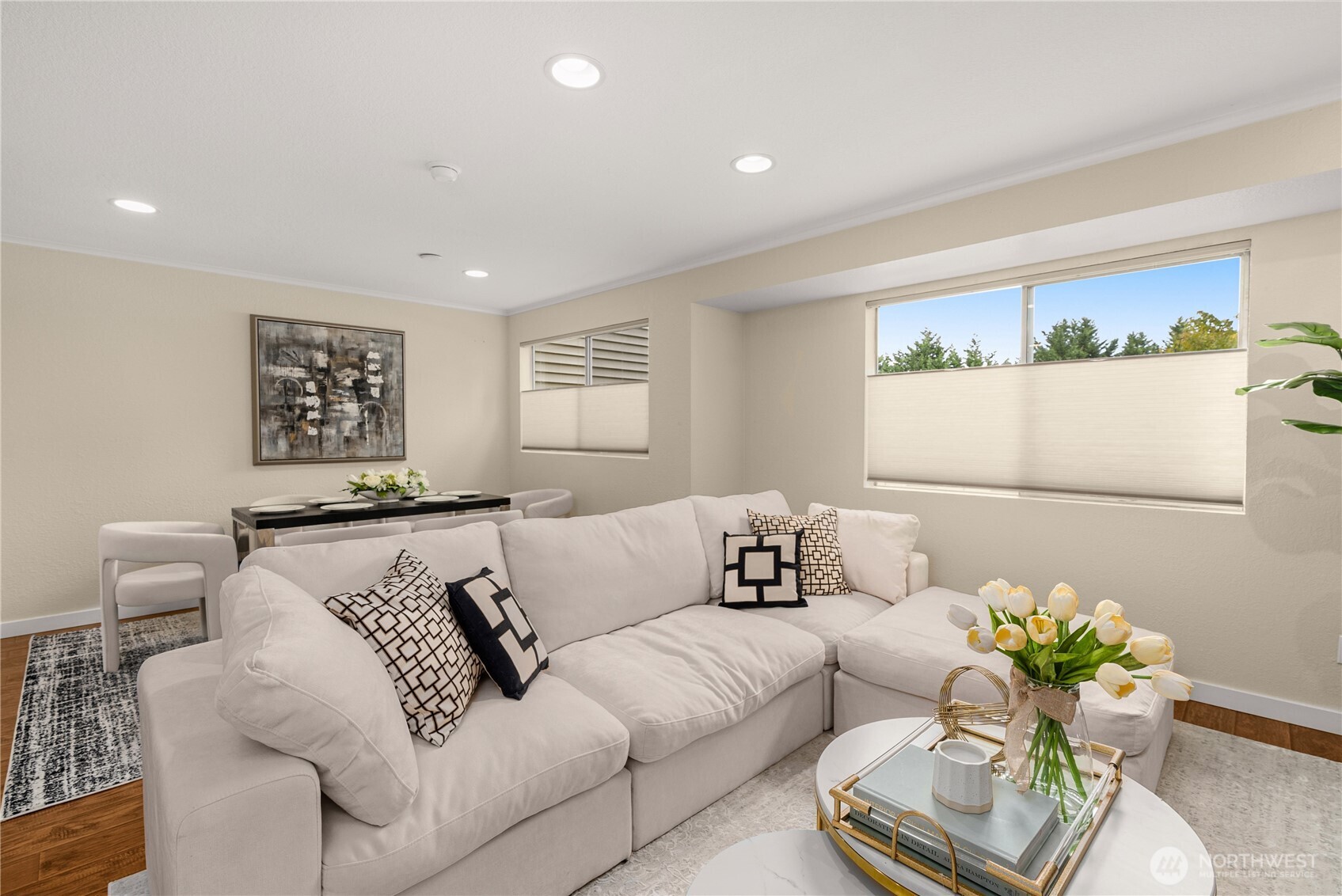Bright living room featuring a wood-burning fireplace and large windows