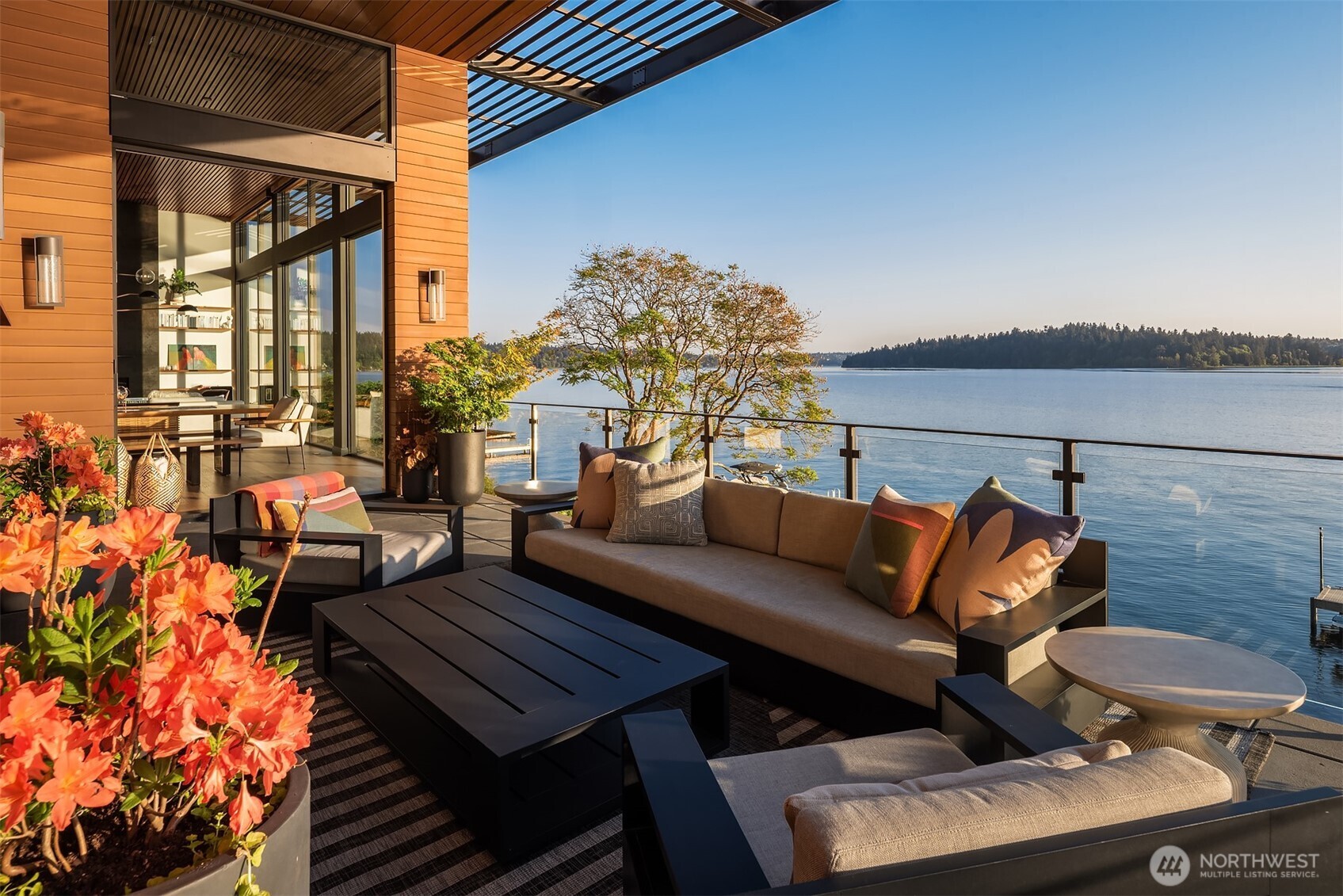 Covered upper deck with outdoor fireplace, grill, and city skyline views