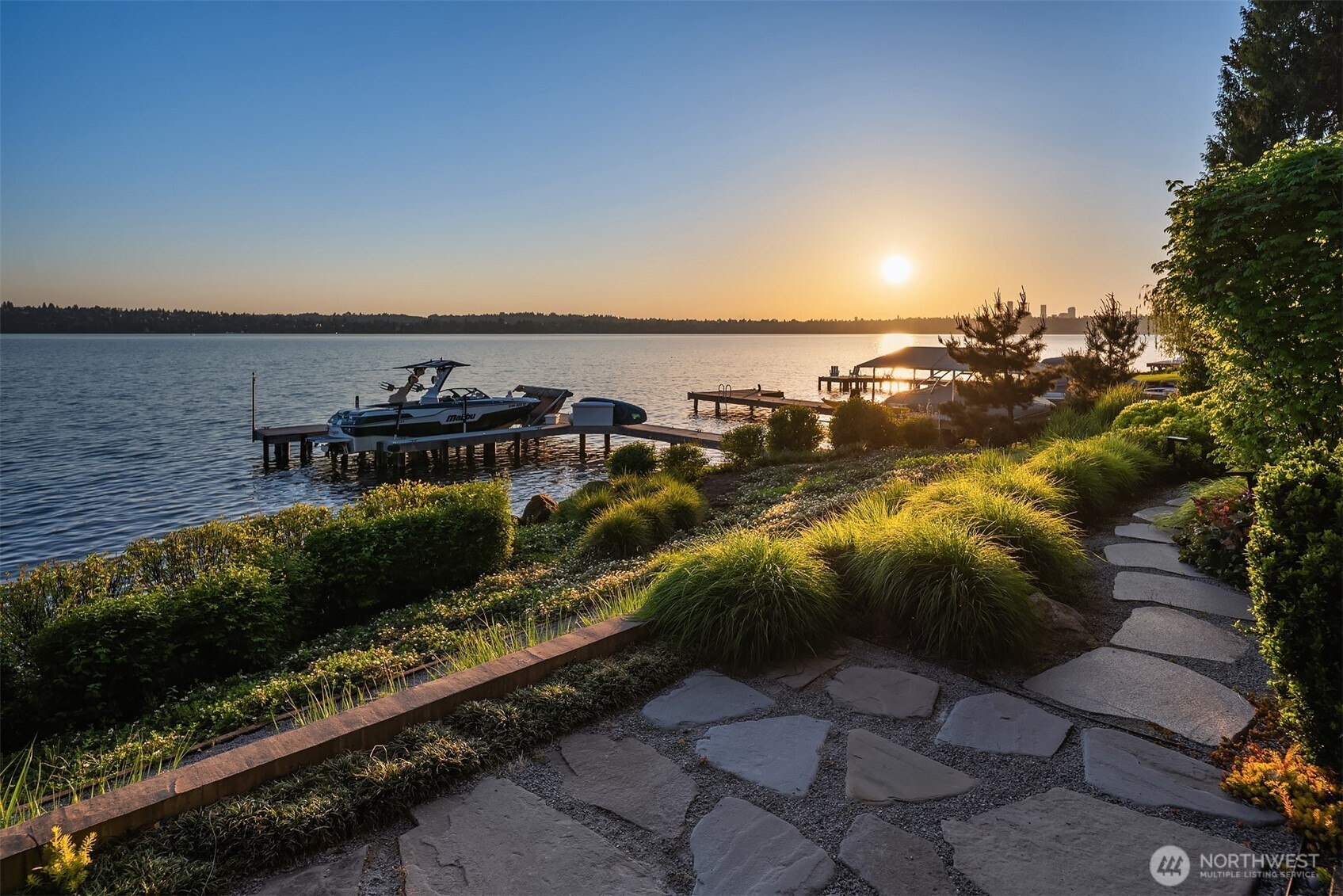Backyard with hot tub and private dock at dusk
