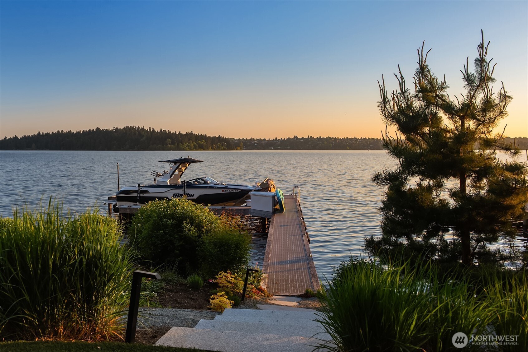 View from the dock across the lake toward the city skyline at sunset