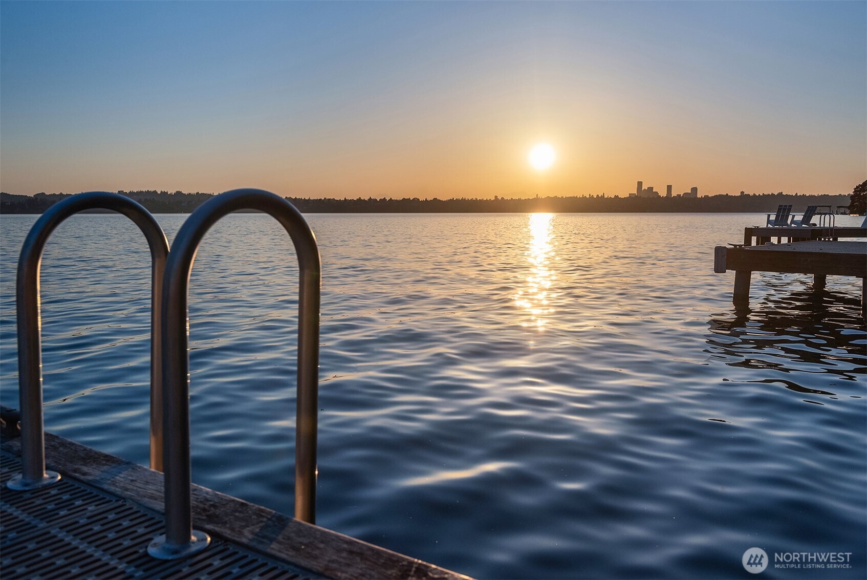 Sunrise view across the lake toward the city skyline