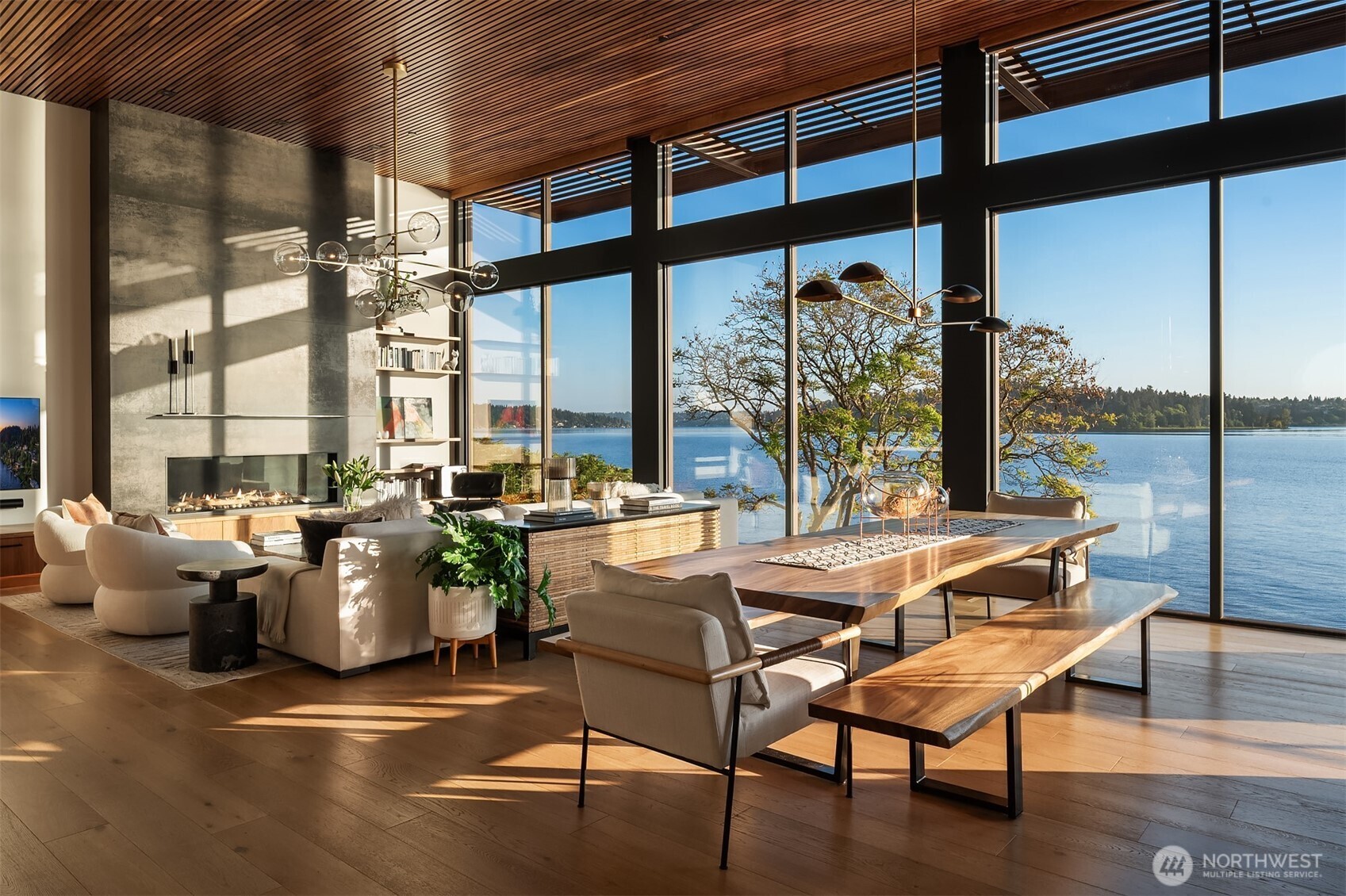 Living room with floor-to-ceiling windows and city skyline views at dusk