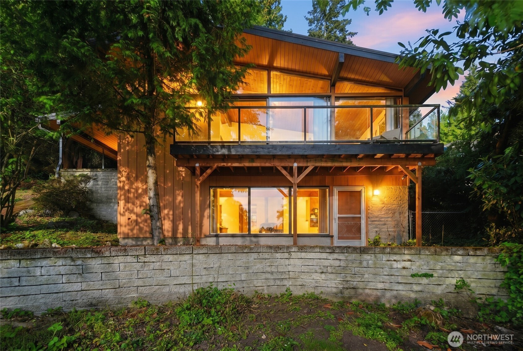 Spacious lower level with large windows glazing across the lake.