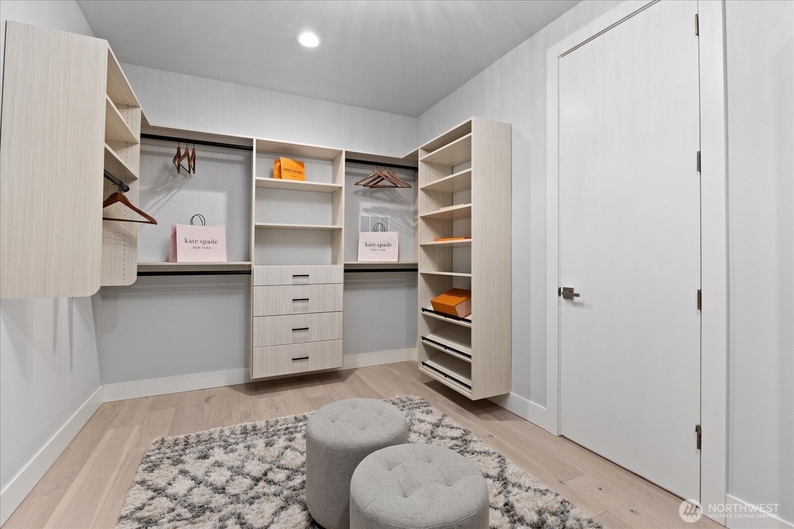 The custom walk-in closet offers built-in organization, generous storage, and a private dressing room feel, adding function and luxury to the primary suite in this Kirkland North Rose Hill home.