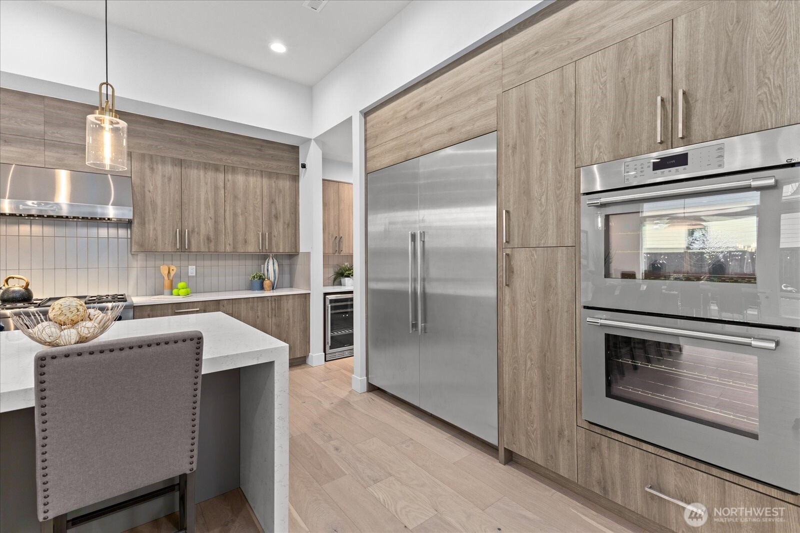 From the 60” integrated Thermador refrigerator to the double ovens, wine chiller, and professional-grade gas range, this chef’s kitchen is designed for precision, function, and elevated everyday living in this Kirkland North Rose Hill luxury home.