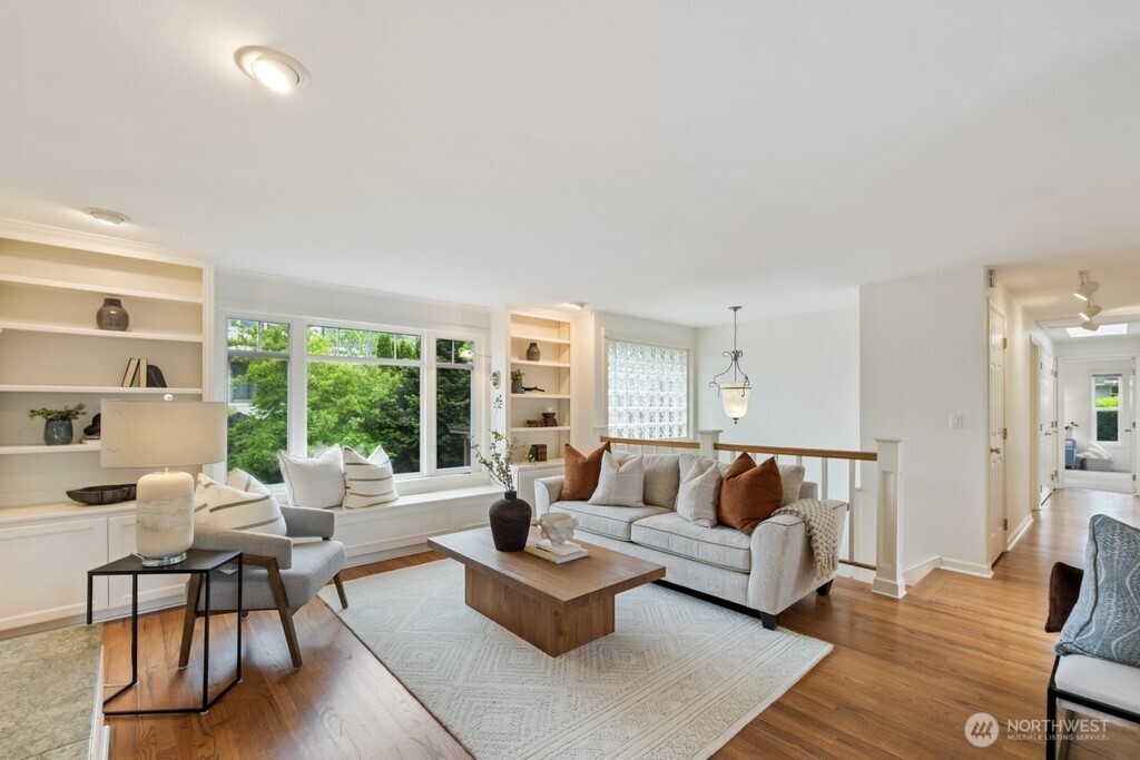 Inviting light and bright living area with hardwood floors, and tons of built-in smart storage solutions throughout the home.