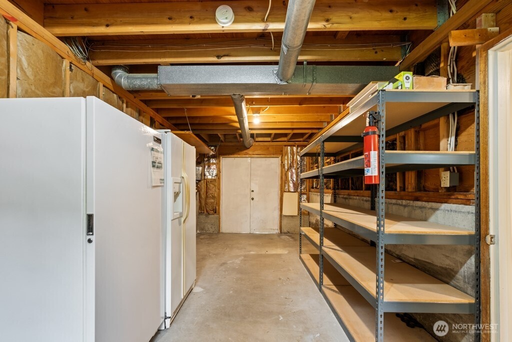 Full size shop on lower level with tons of storage areas and backyard access