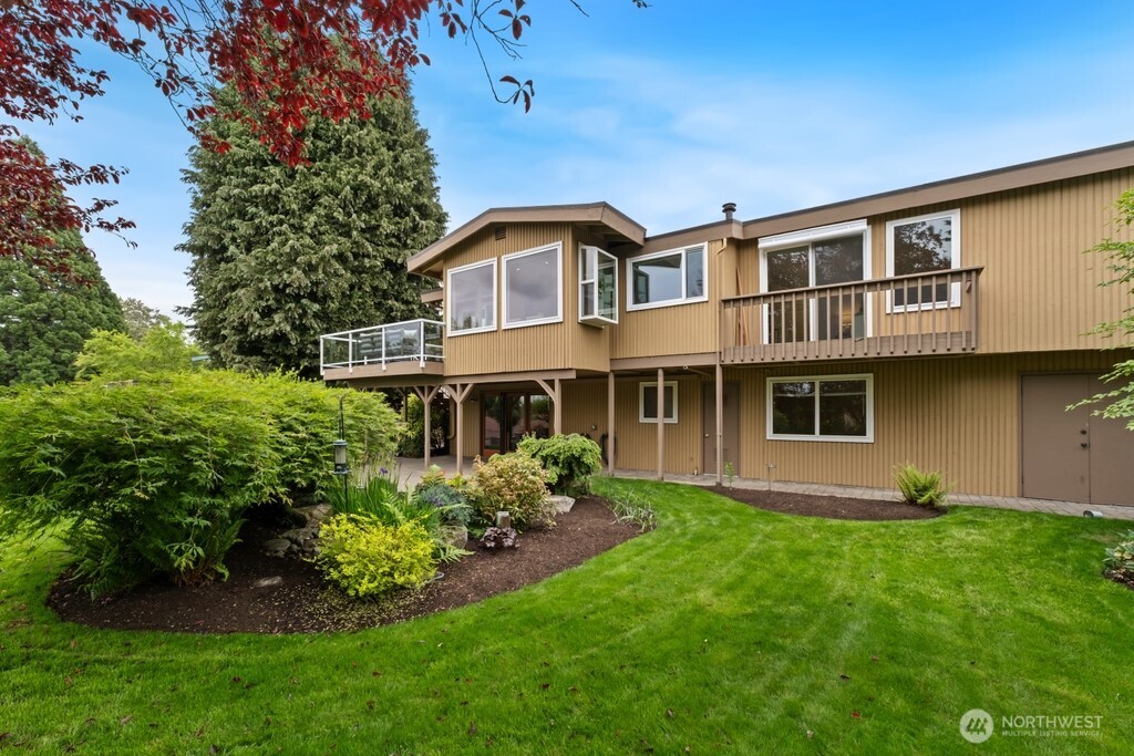 Super-sized manicured fenced yard with lovely water feature, spectacular garden areas and plenty of room for pets and playtime