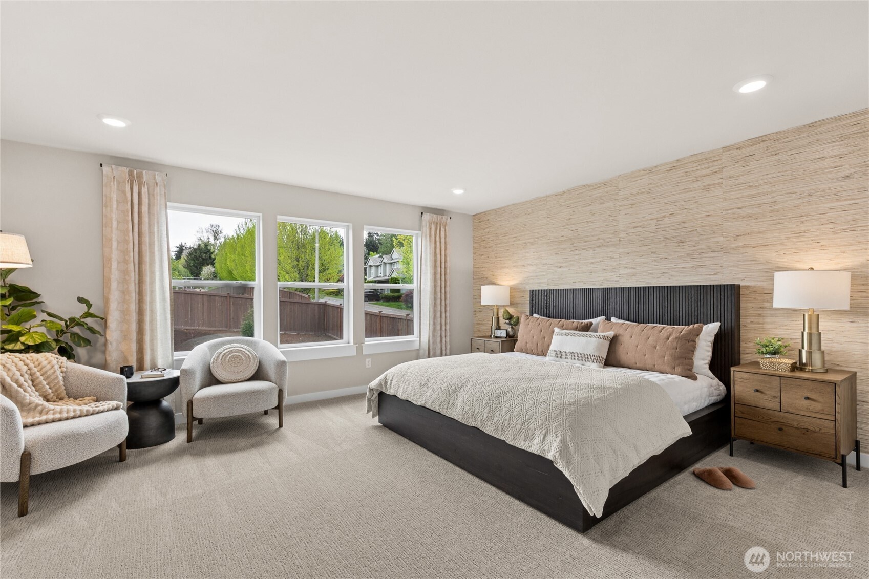 Primary suite is a quiet refuge offering double doors and ample room for oversized King bed