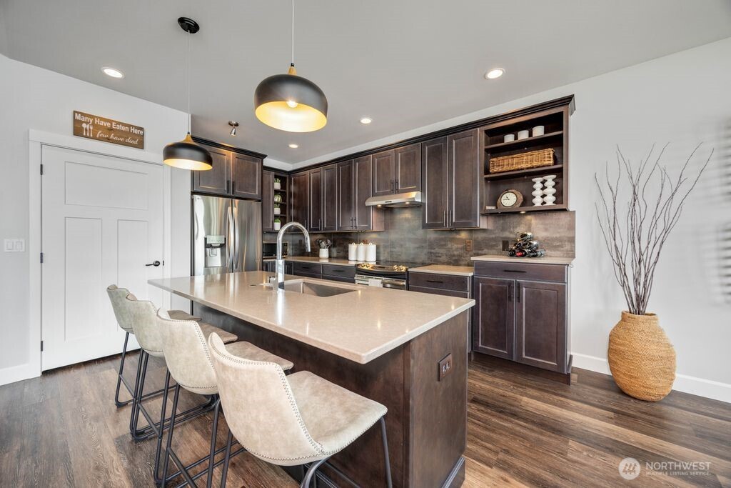 Notice the hi-low counter configuration on the right. This makes the perfect coffee bar or wine station. The pantry is to the left of the refrigerator.