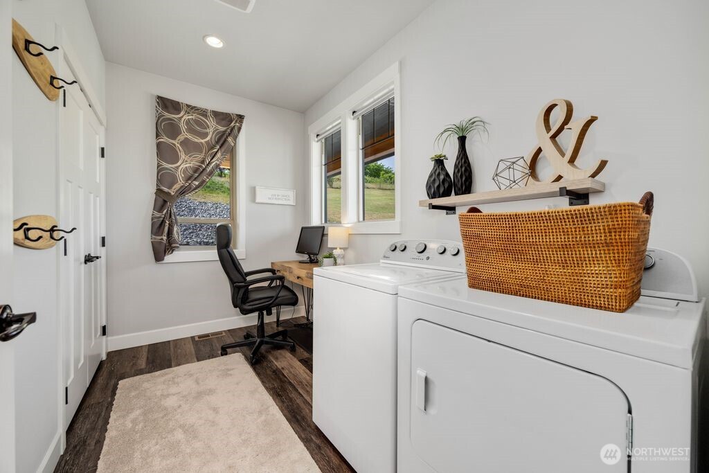 Thoughtfully located main floor laundry, offers room for folding counter, ironing board, or a hidden home office. There is a door to the right of the laundry room to the side porch.