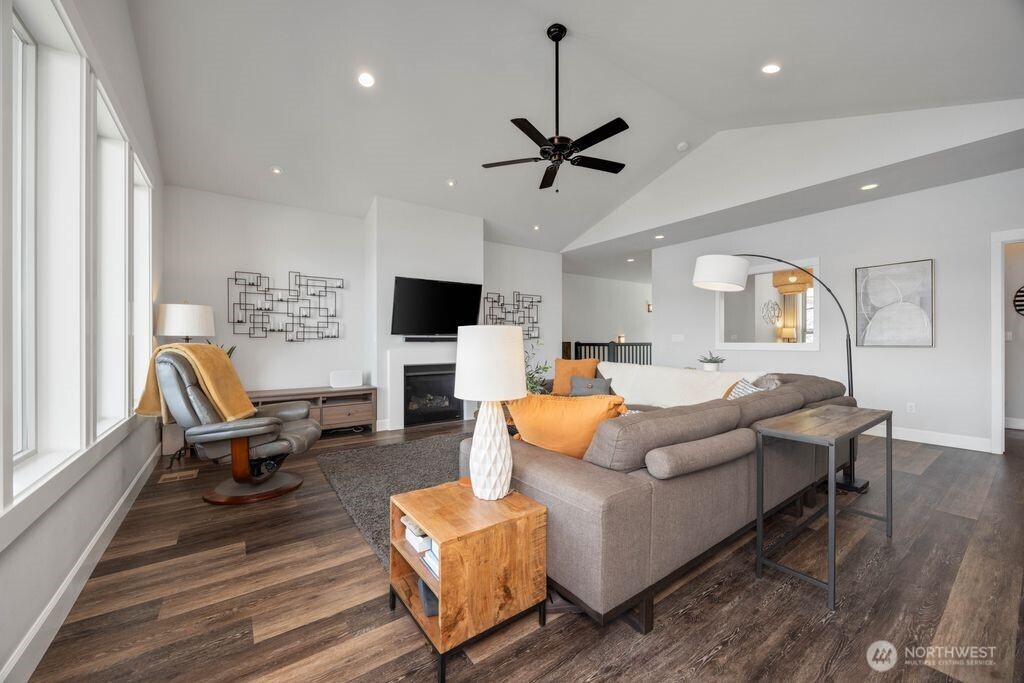 Focal propane fireplace, expansive windows, luxury vinyl plank flooring.