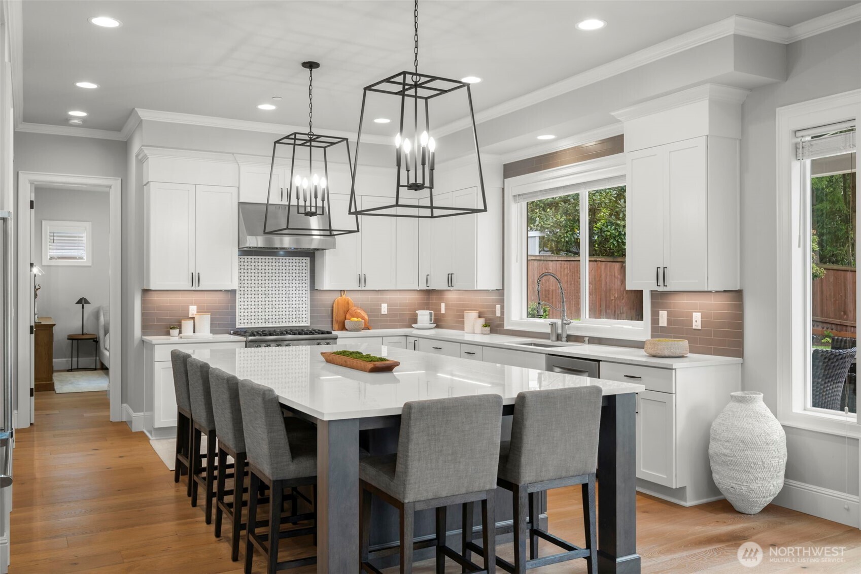 Custom quartz island and designer lighting