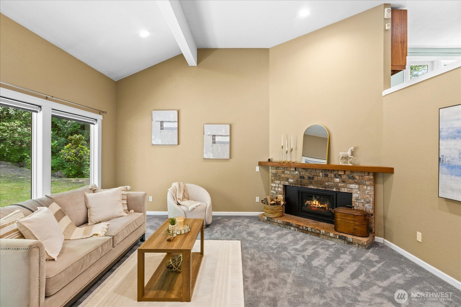 Airy living room off the entry with a gas fireplace.