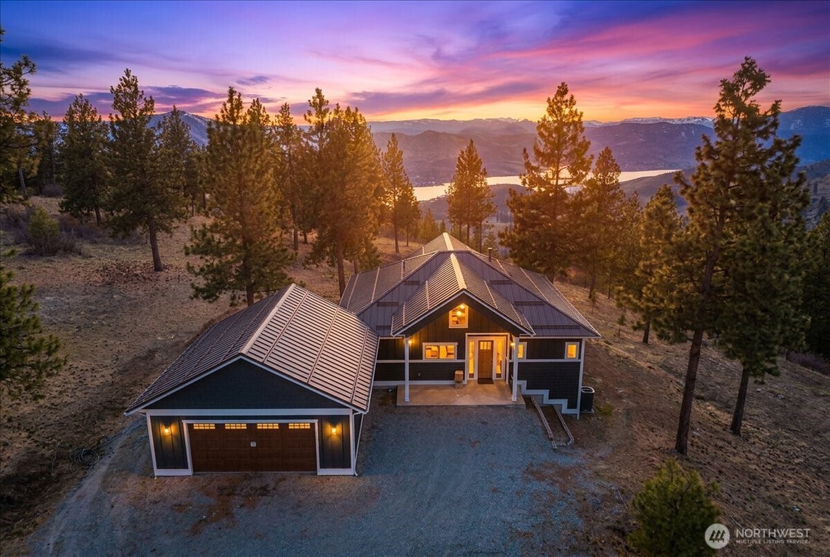 Twilight View of back of home wtih all windows, decks and architecture design