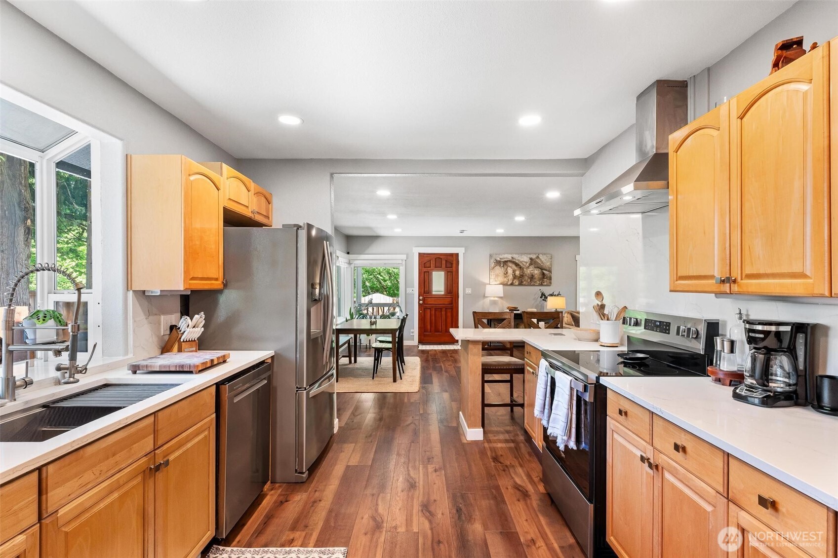 Updated kitchen with quartz countertops and stainless steel appliances.