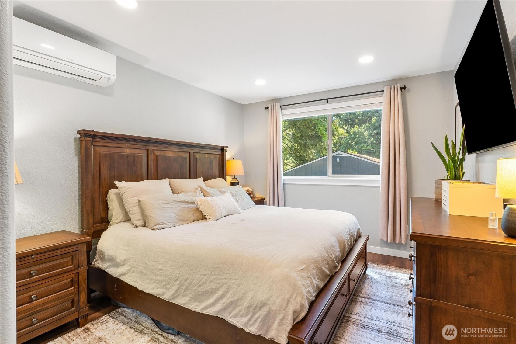Spacious primary bedroom with peaceful views.