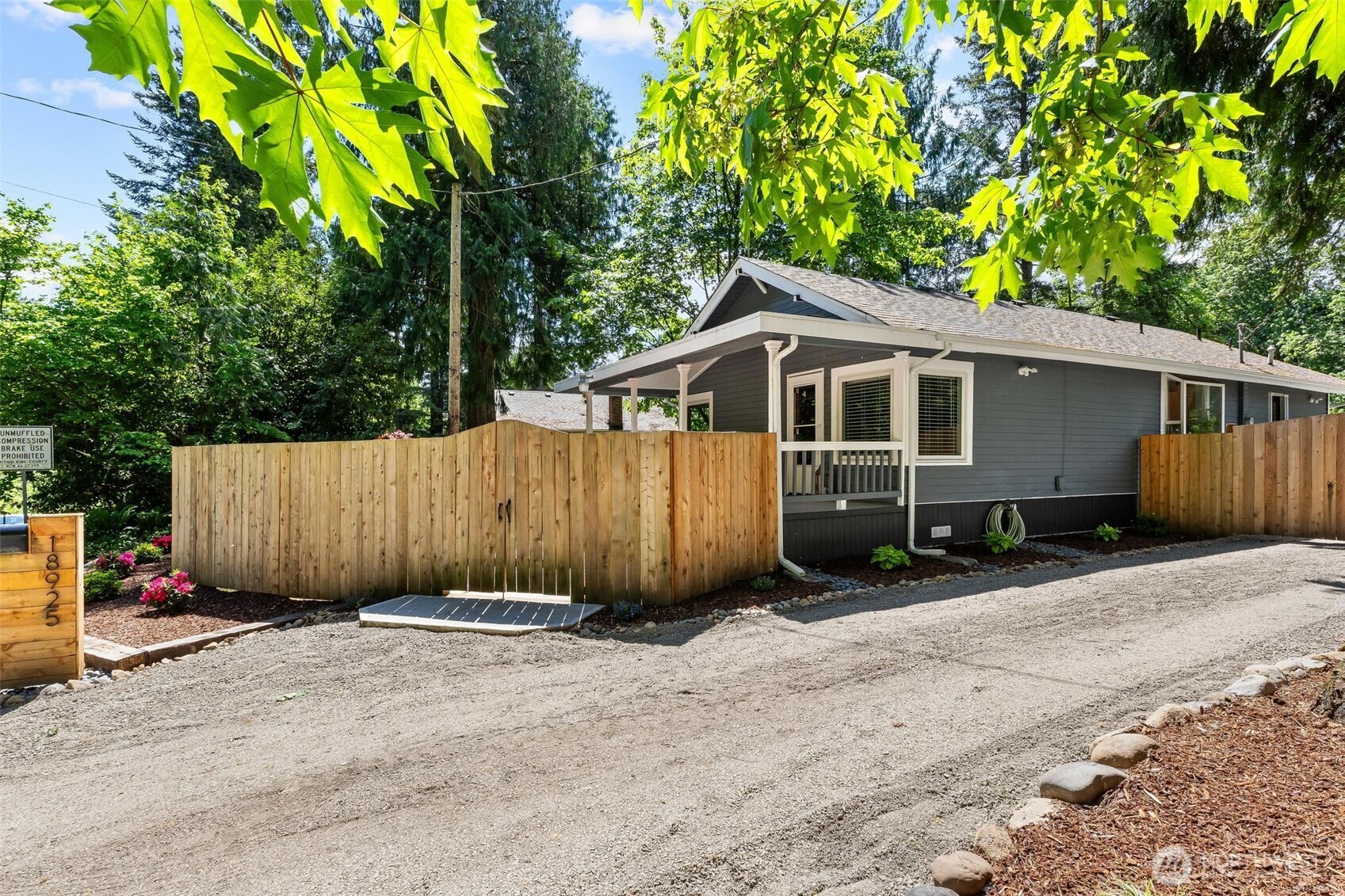 Charming exterior surrounded by mature trees.