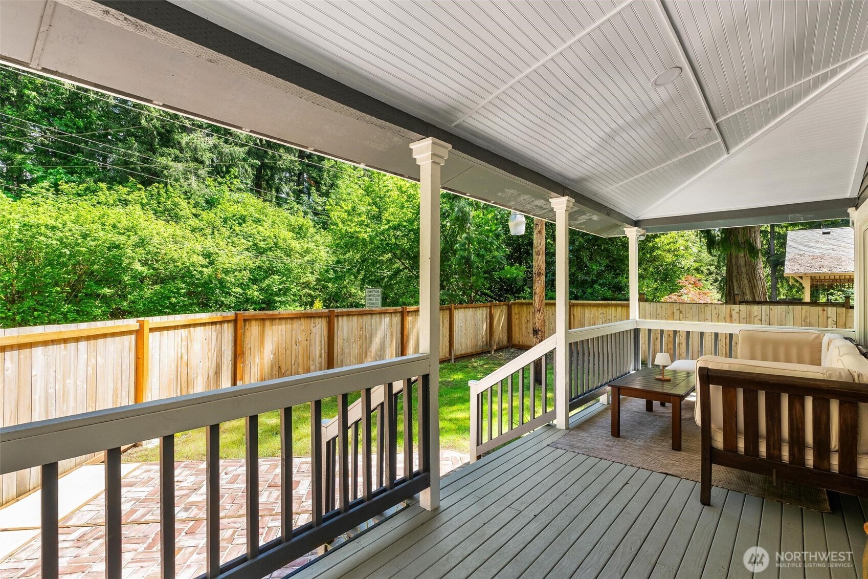 Spacious front porch overlooking peaceful surroundings.