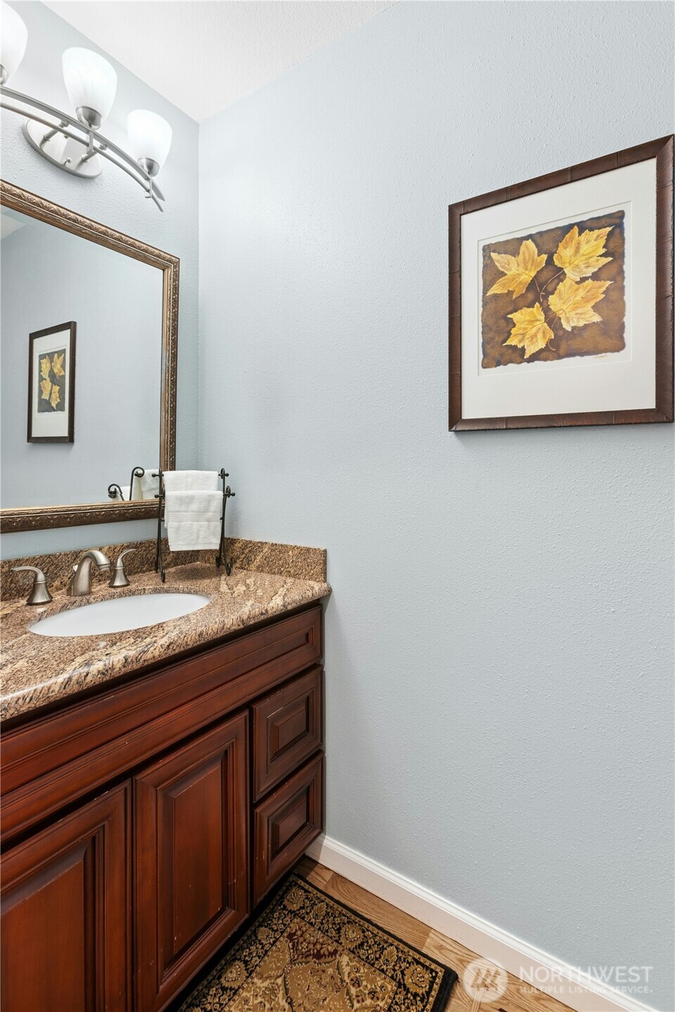 View from the kitchen to the main level powder room and dining room. Another notable upgrade: interior doors have been replaced with solid wood doors and new door hardware.