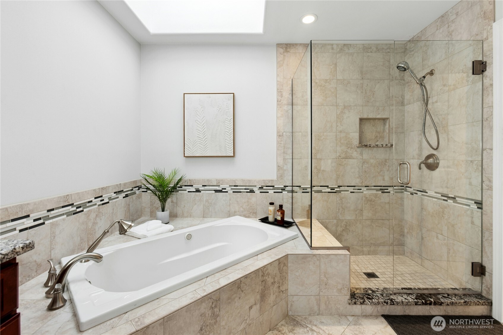 This luxurious, updated 5-piece bath has a skylight, heated floors, a heated towel bar and a bubble massage tub.