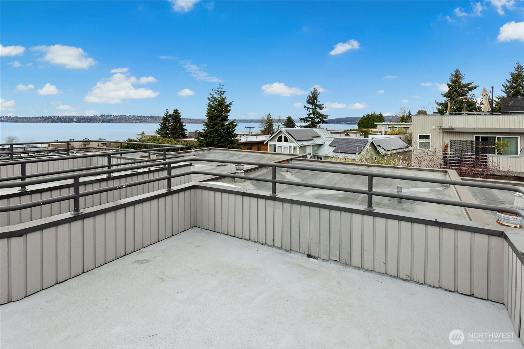 The roof top deck has lake, city and mountain views! The half door leads to the hardwood stairs and the upper level.