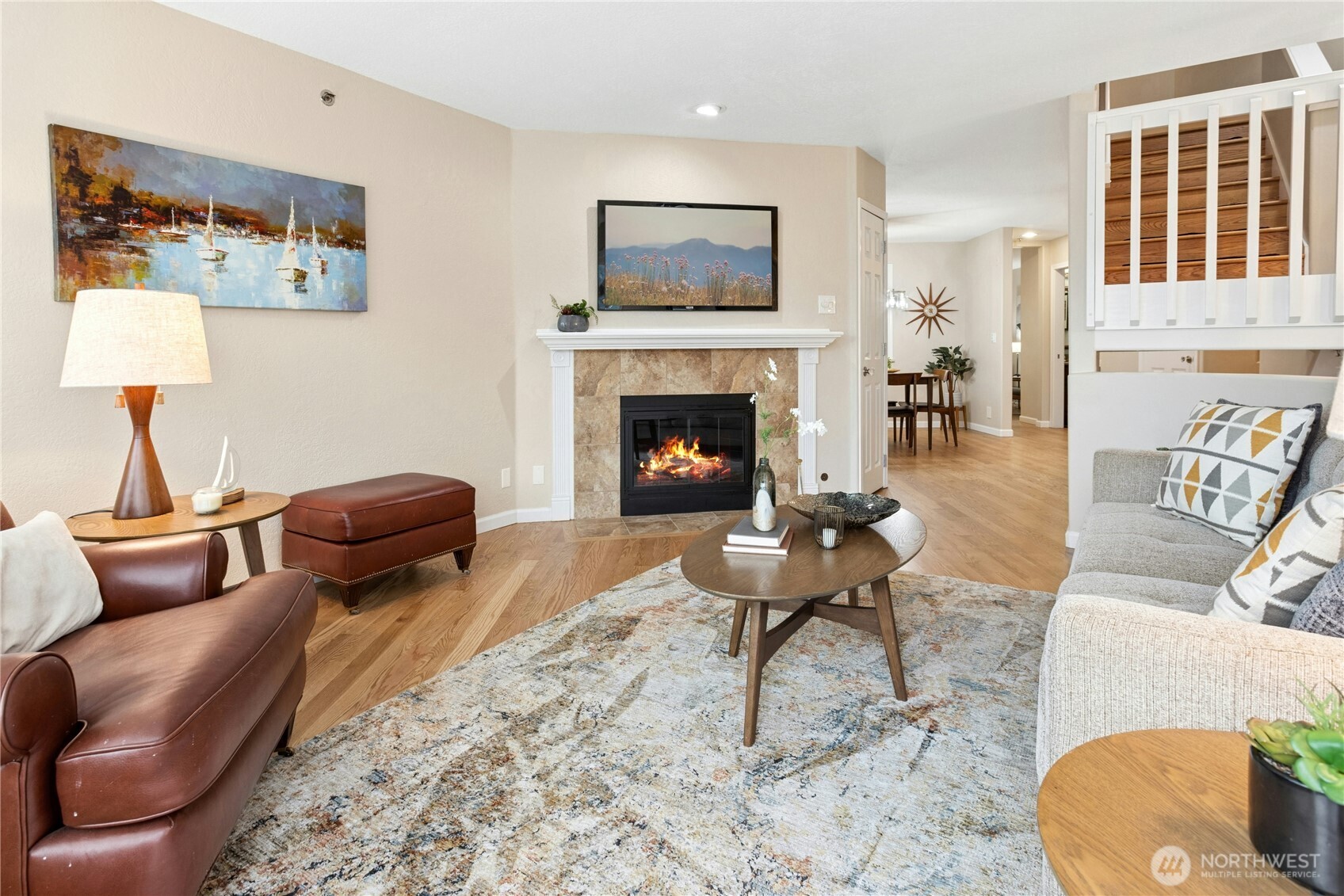 Here is another look at the living room with gleaming hardwood floors and a newer gas fireplace insert.
