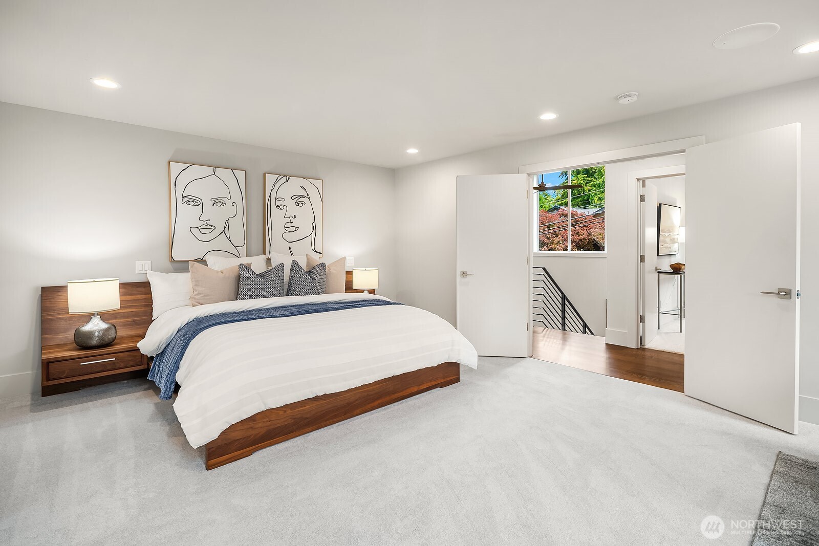 Double doors leading to luxurious upper-level primary suite