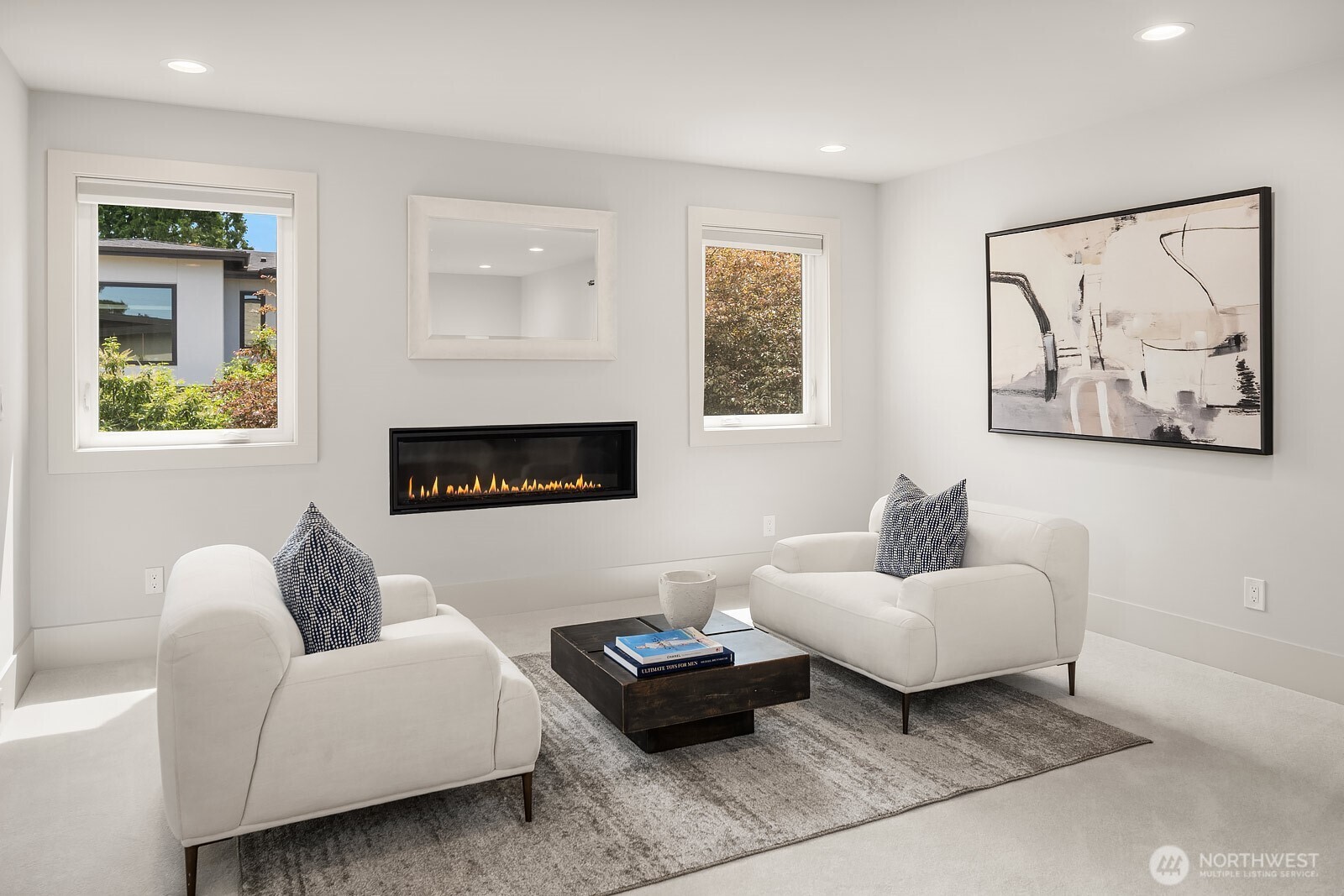 Upper-level primary suite with sitting area and gas fireplace