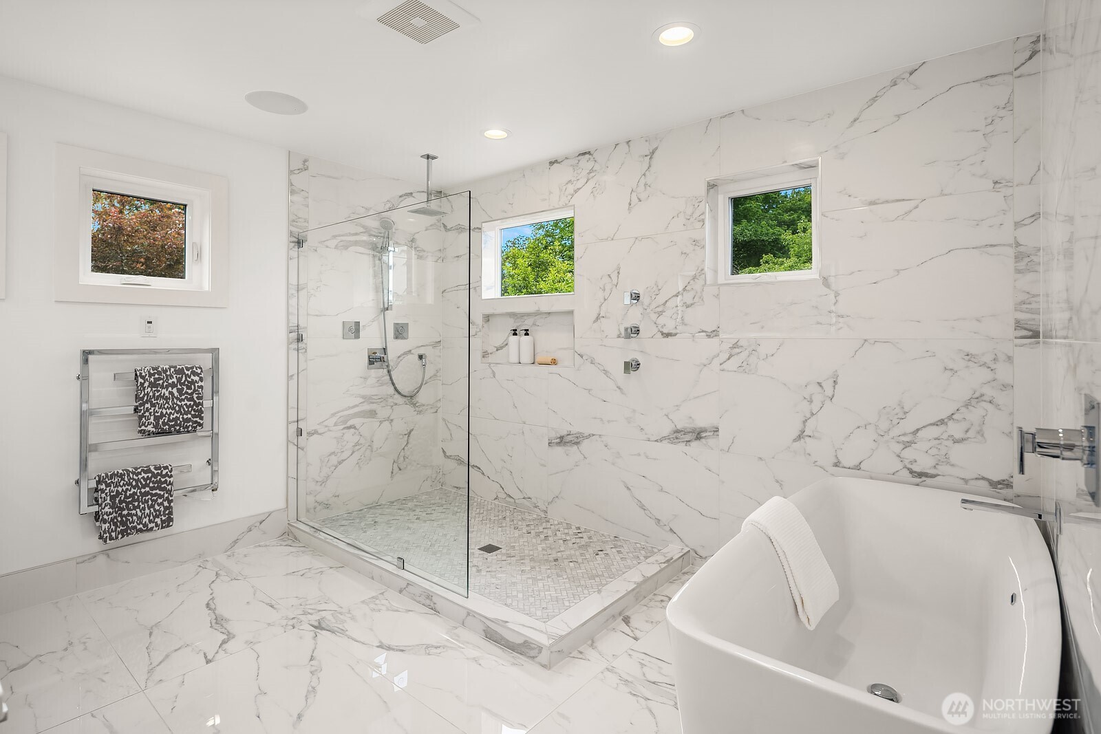 Retreat to the spa-inspired upper-level primary bathroom