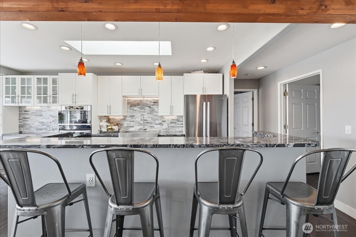 Fully updated kitchen with bar seating, gorgeous tilework