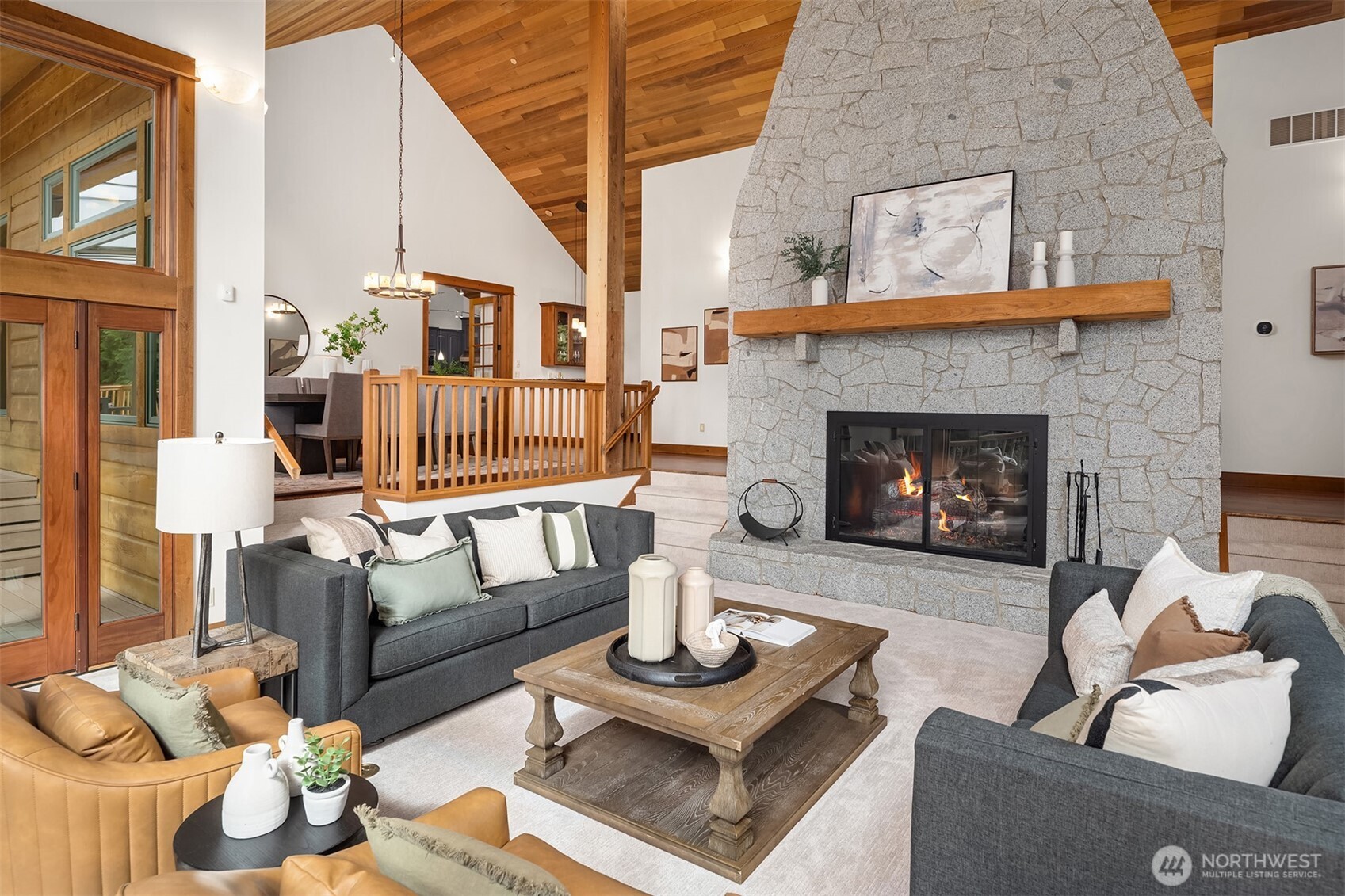 Offering 3 fireplaces-one with a dynamic floor to ceiling live edge granite surround.