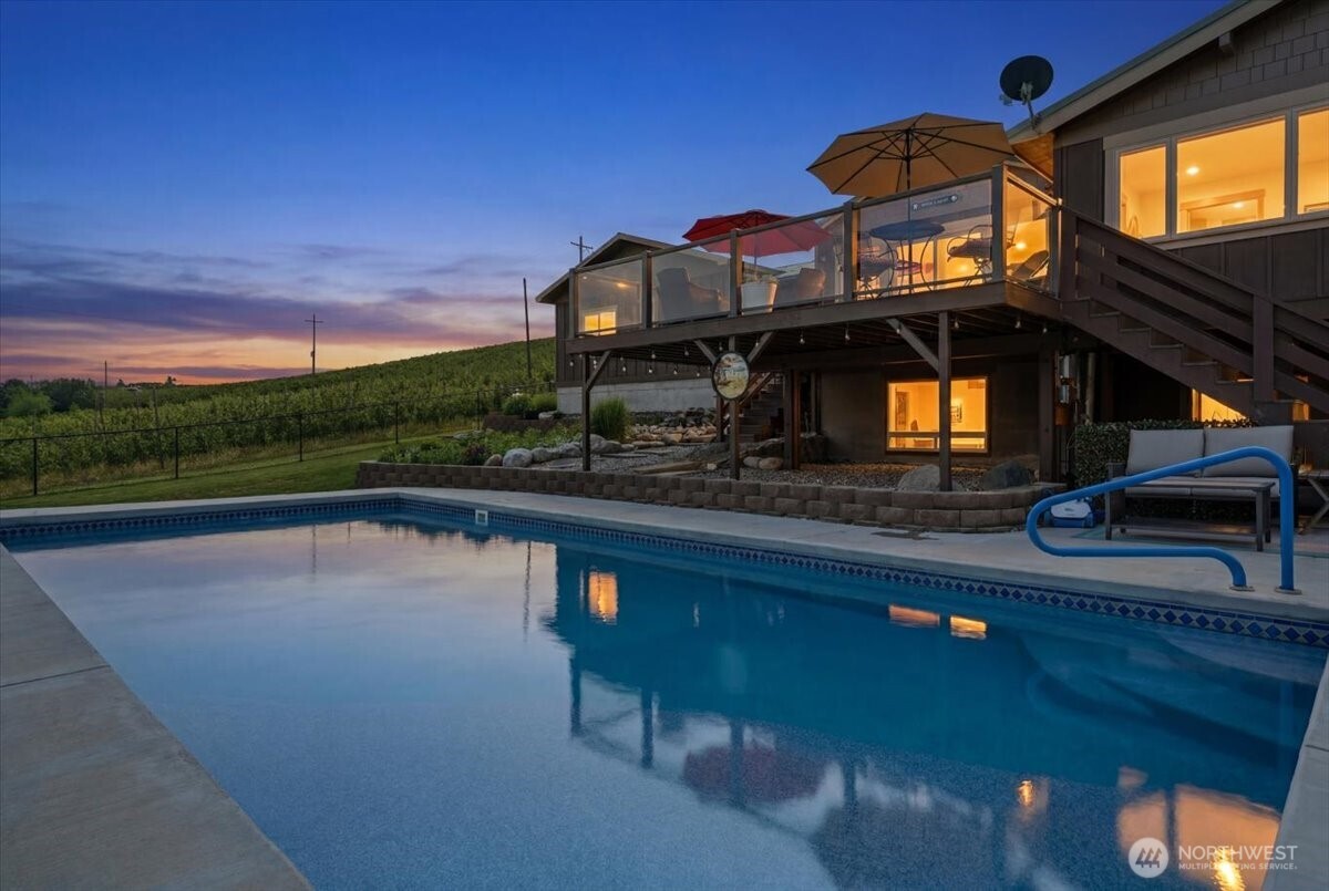 Twilight exterior of home pool and hobby shop