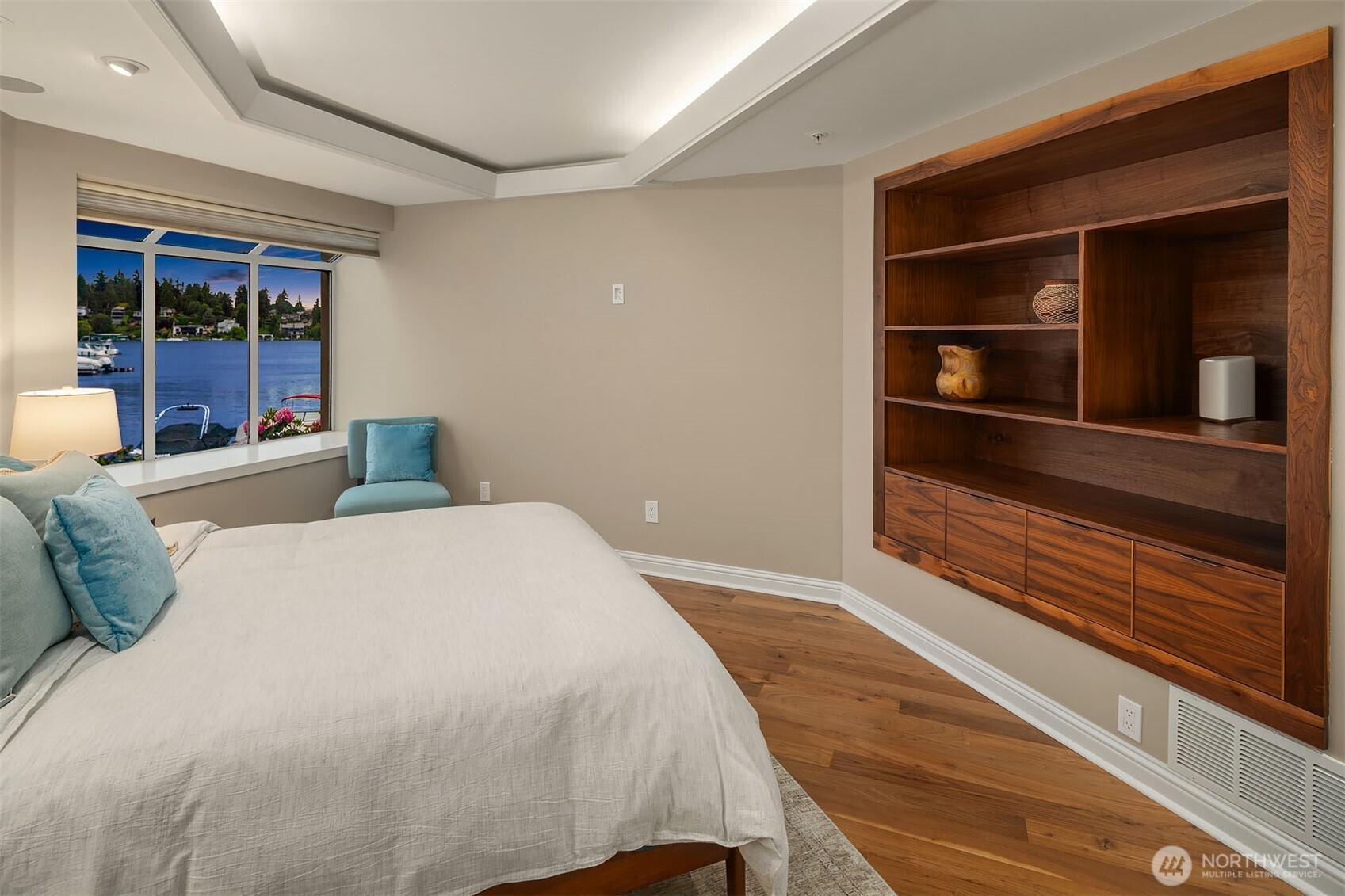The details here are worth a closer look — a custom walnut built-in with open shelving and cabinet storage adds warmth and function in equal measure, while a window seat perched above the marina invites quiet mornings with coffee and a front-row view of life on the water. This would make a fabulous home office as well!