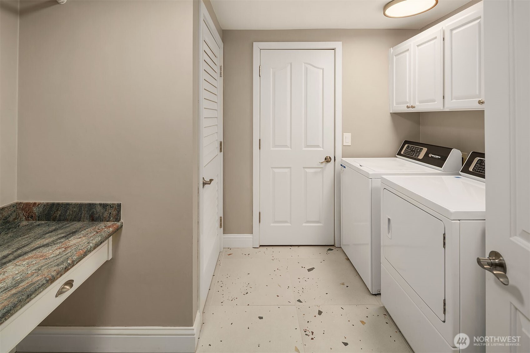 Not all heroes wear capes — the laundry room earns its keep with commercial-grade Speed Queen appliances built to outlast the rest, generous cabinet storage behind every door, and a folding table that makes the chore almost enjoyable. Function elevated to an art form, right down to the last detail.