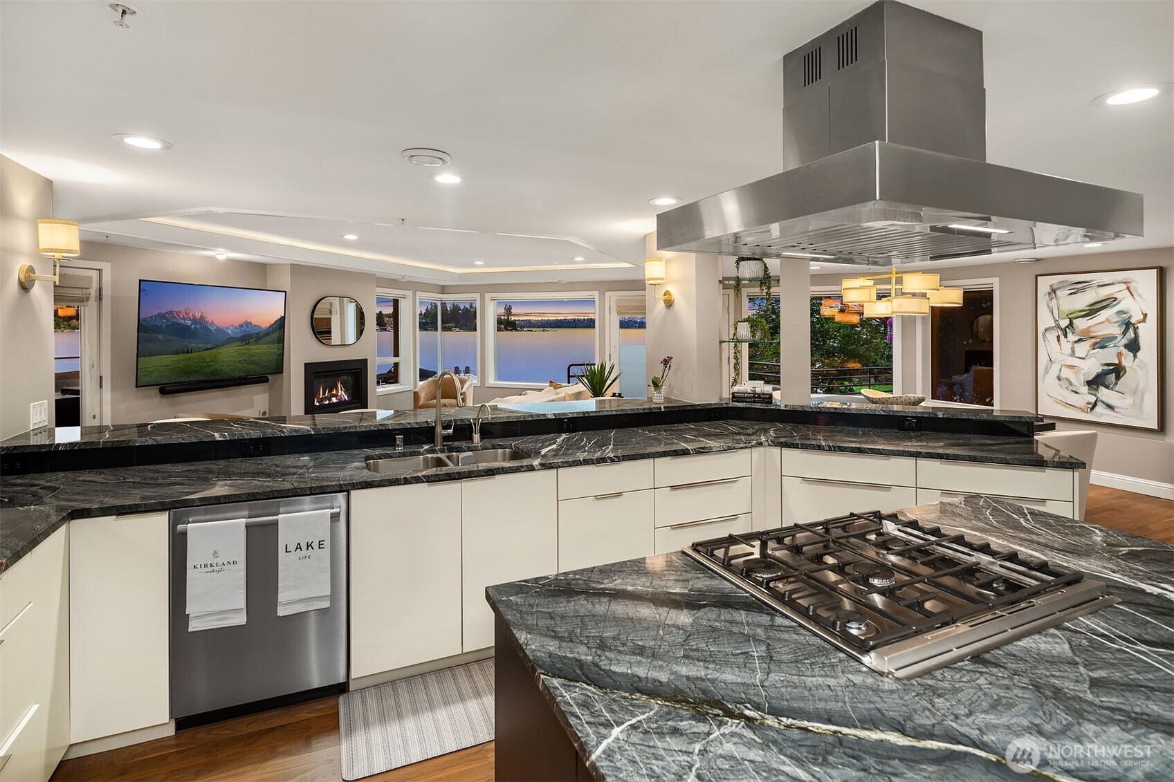 A professional range anchored beneath a stainless hood and a sprawling prep island make this as functional as it is stunning — while bar seating for five keeps the conversation flowing, always.